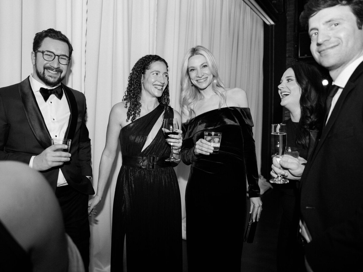 Black and white photo of guests at the wedding reception. 