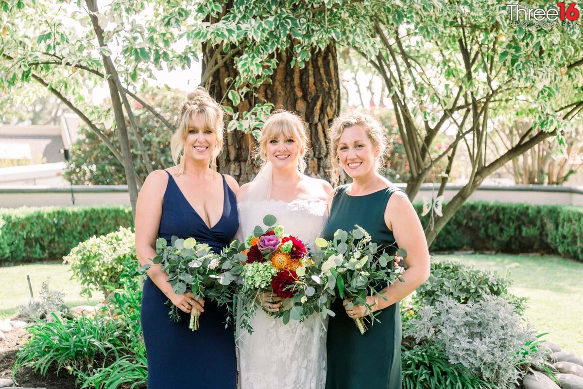 Bride poses for a photo with her bridesmaids
