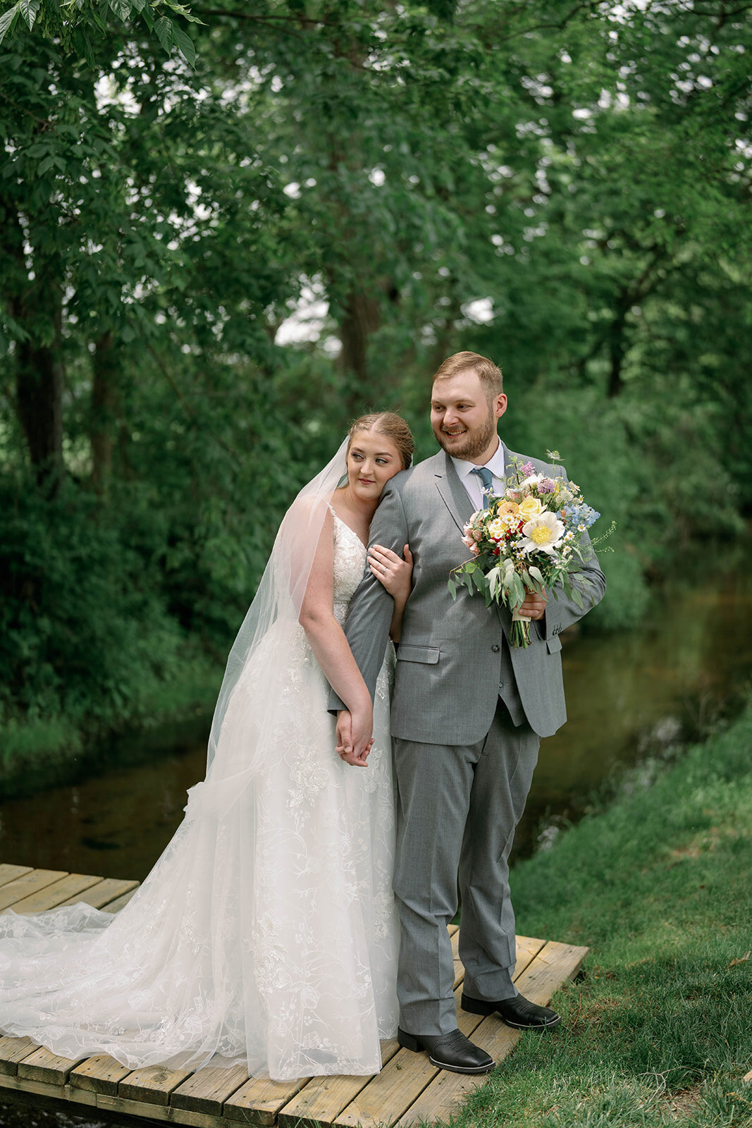 Classic photo of the bride and groom standing together during their wedding portraits at The Blue Heron Barn.