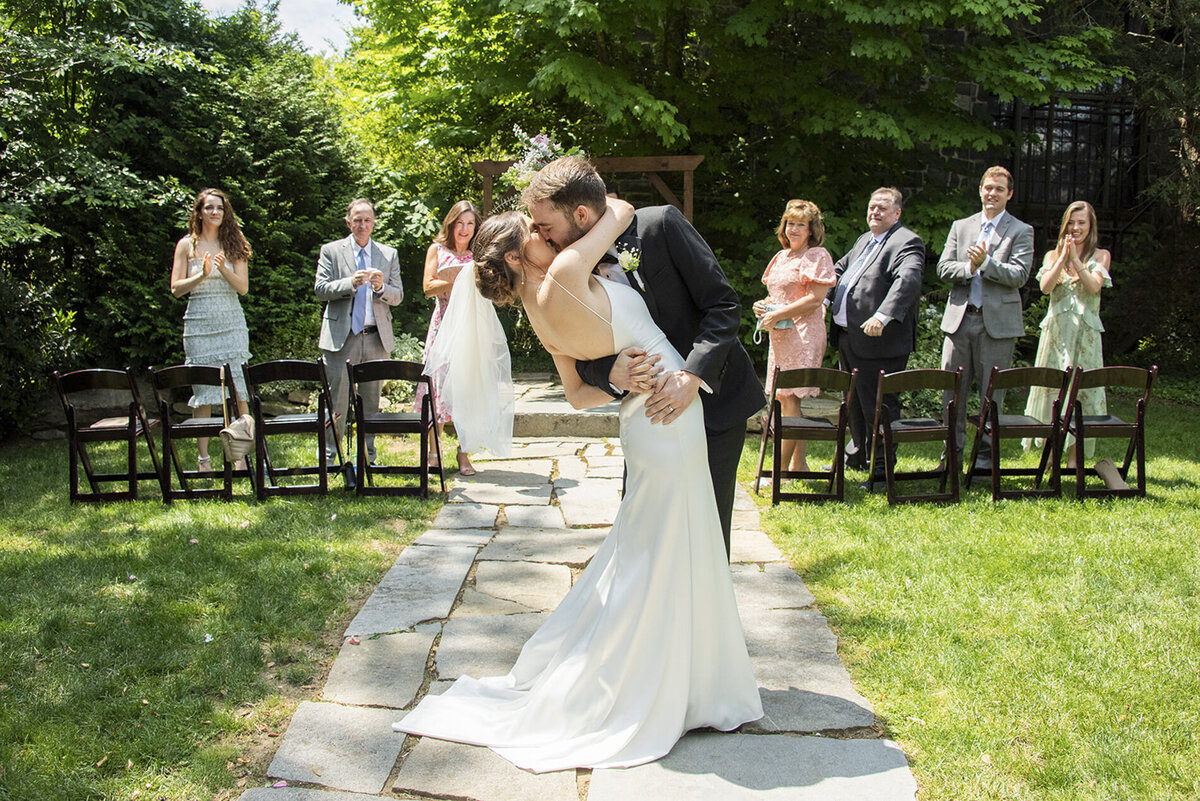 Couple kissing in wedding aisle aisle at Homewood Asheville