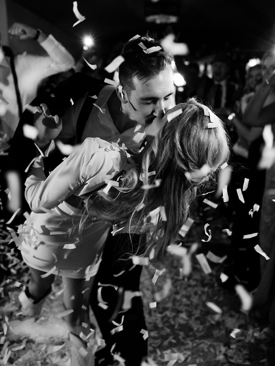 Bride groom reception departure kiss confetti by Sarah Bradshaw