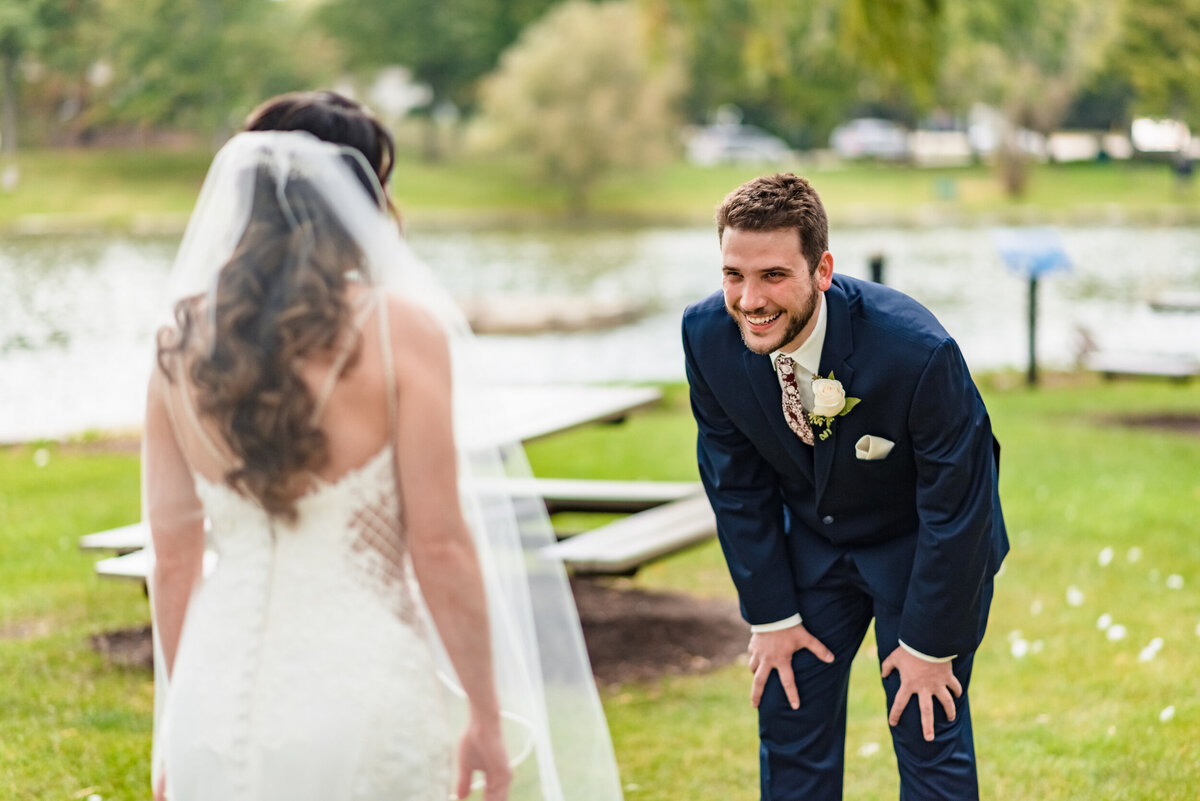 Groom reacts during the first look with his bride