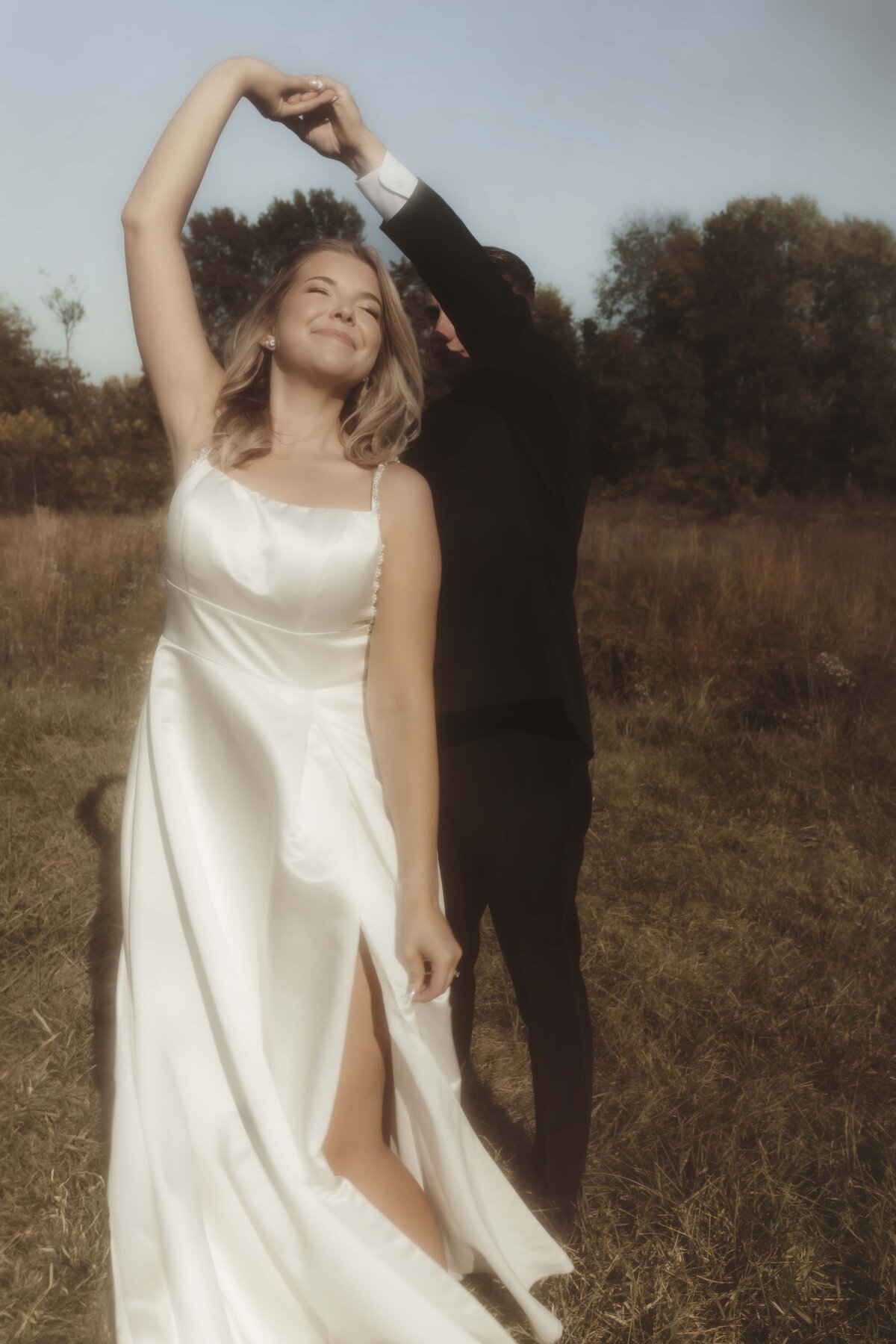 Bride and groom dance at outdoor wedding venue in Springfield Missouri with warm and romantic vibes
