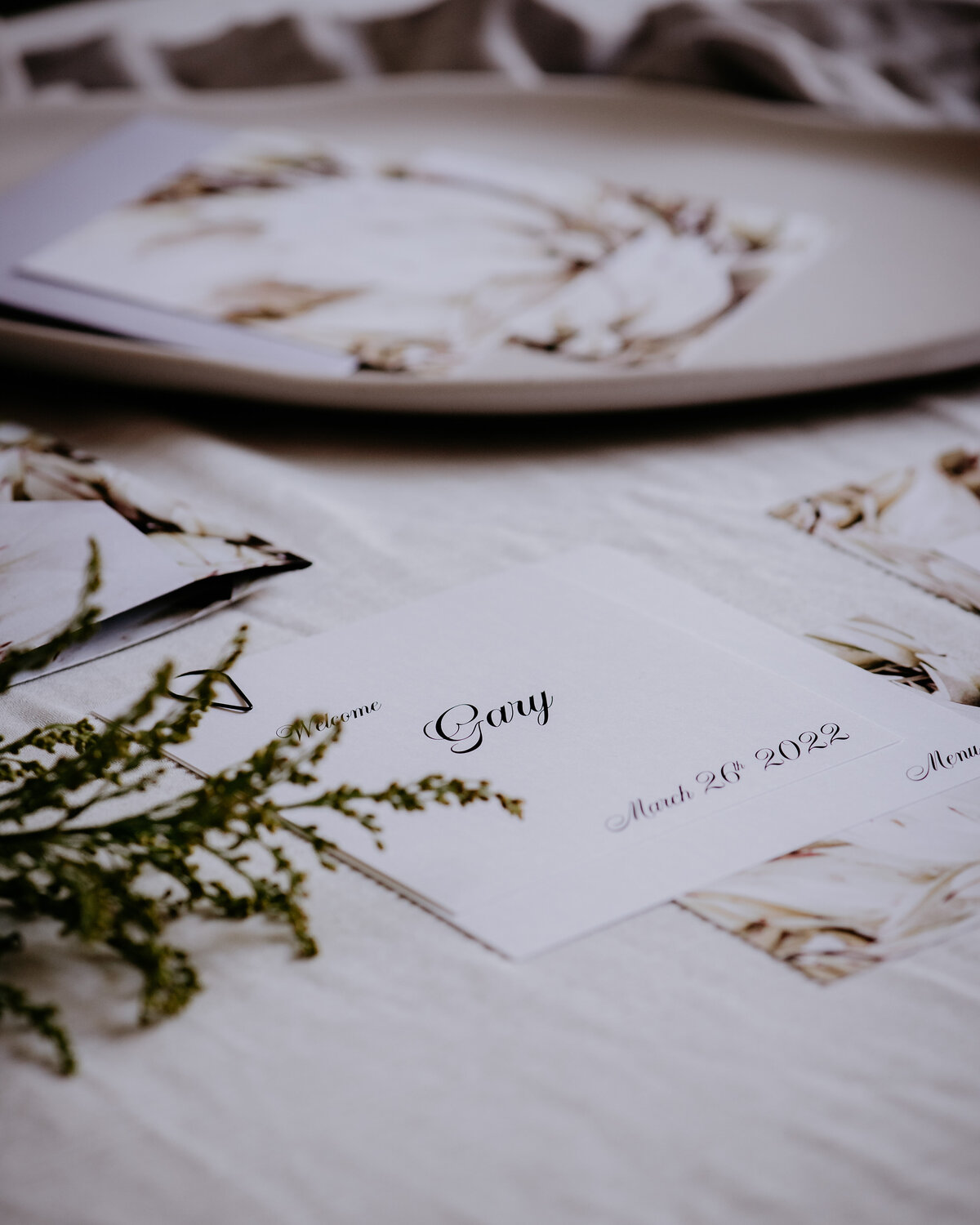 Layered wedding menu and place card with elegant script font and cream flowers
