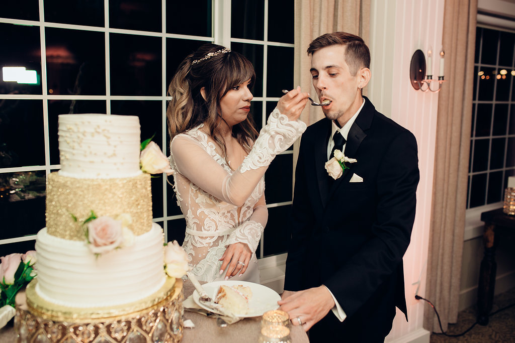 Wedding Photograph Of Bride Feeding The Groom With Cake Los Angeles