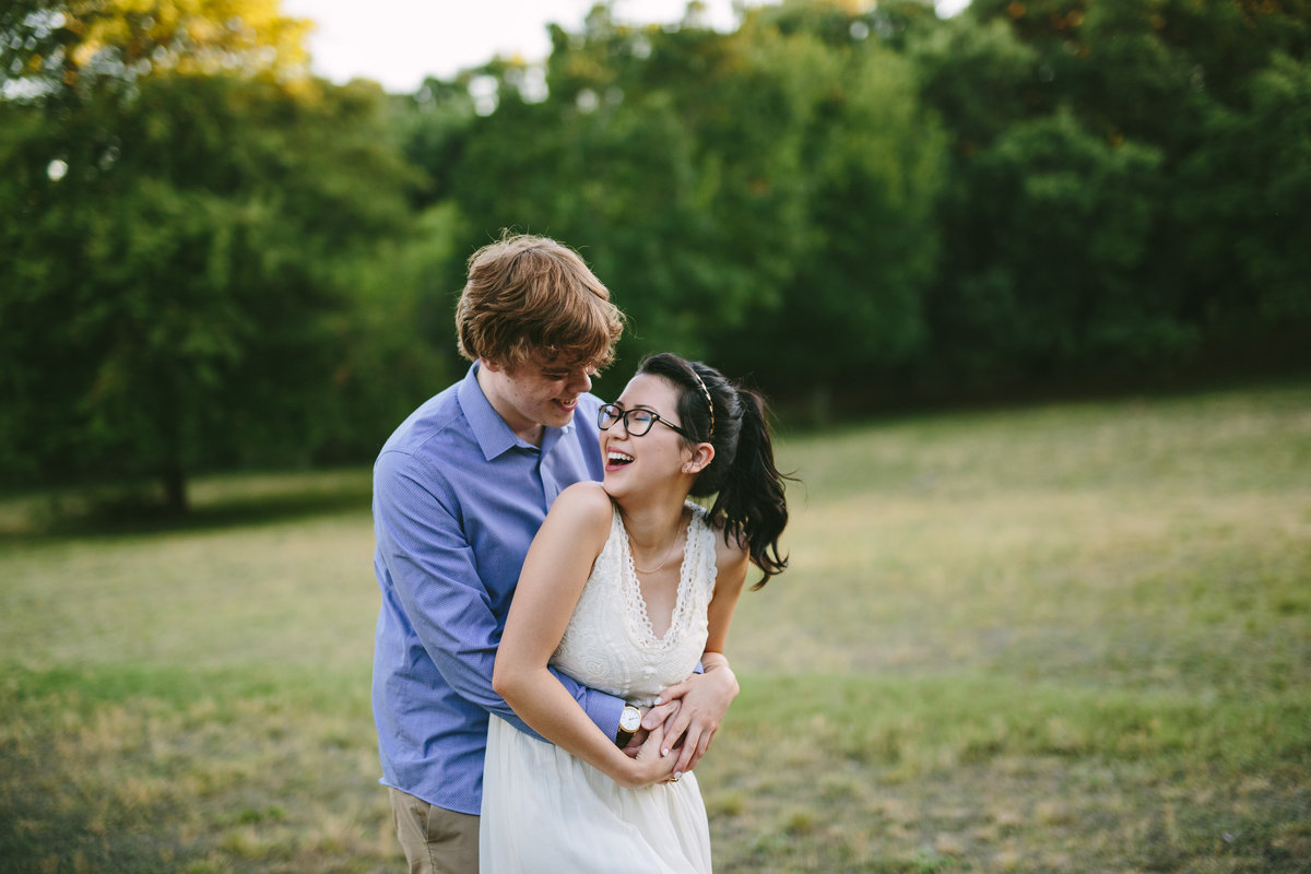 Couple portrait of them hugging and laughing in field by San Antonio Photographer Expose The Heart Photography Denman Estate