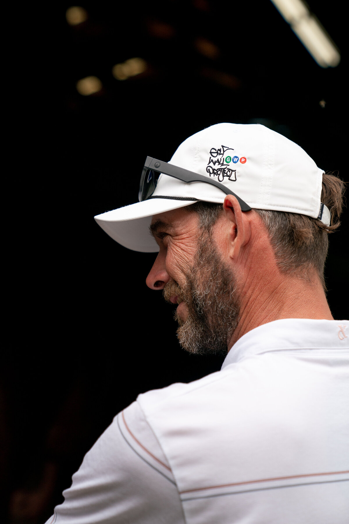 Side Profile portrait of social media influencer Matt Cardis wearing white Adidas Polo and custom Golf In Your State hat at Pinehurst NC Horse Racetrack in 2020.