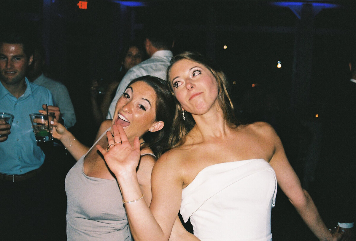 bride and bridesmaid on dance floor