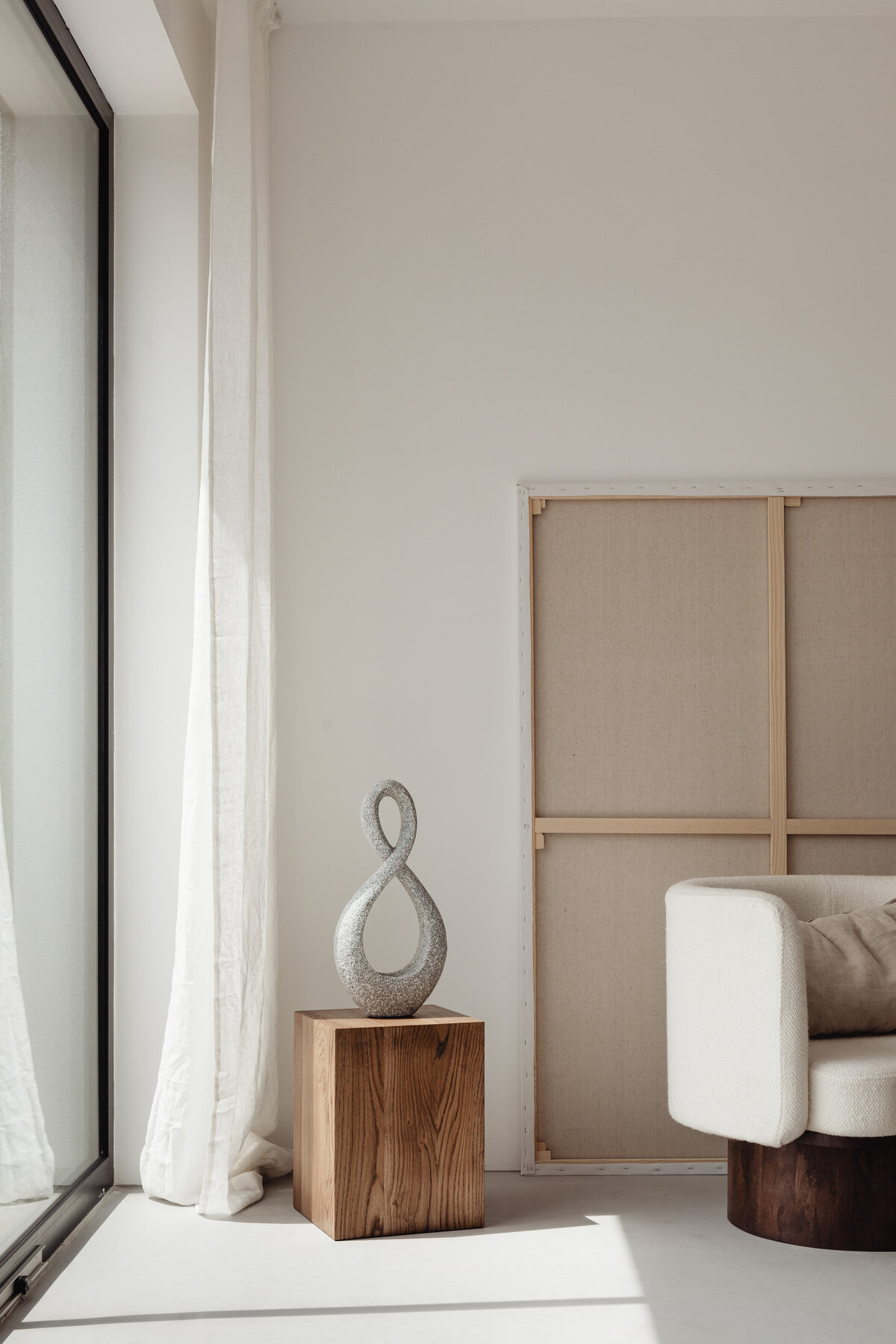kaboompics_Open book - auxiliary table - cube - walnut wood - pedestal - sculpture - upholstered armchair