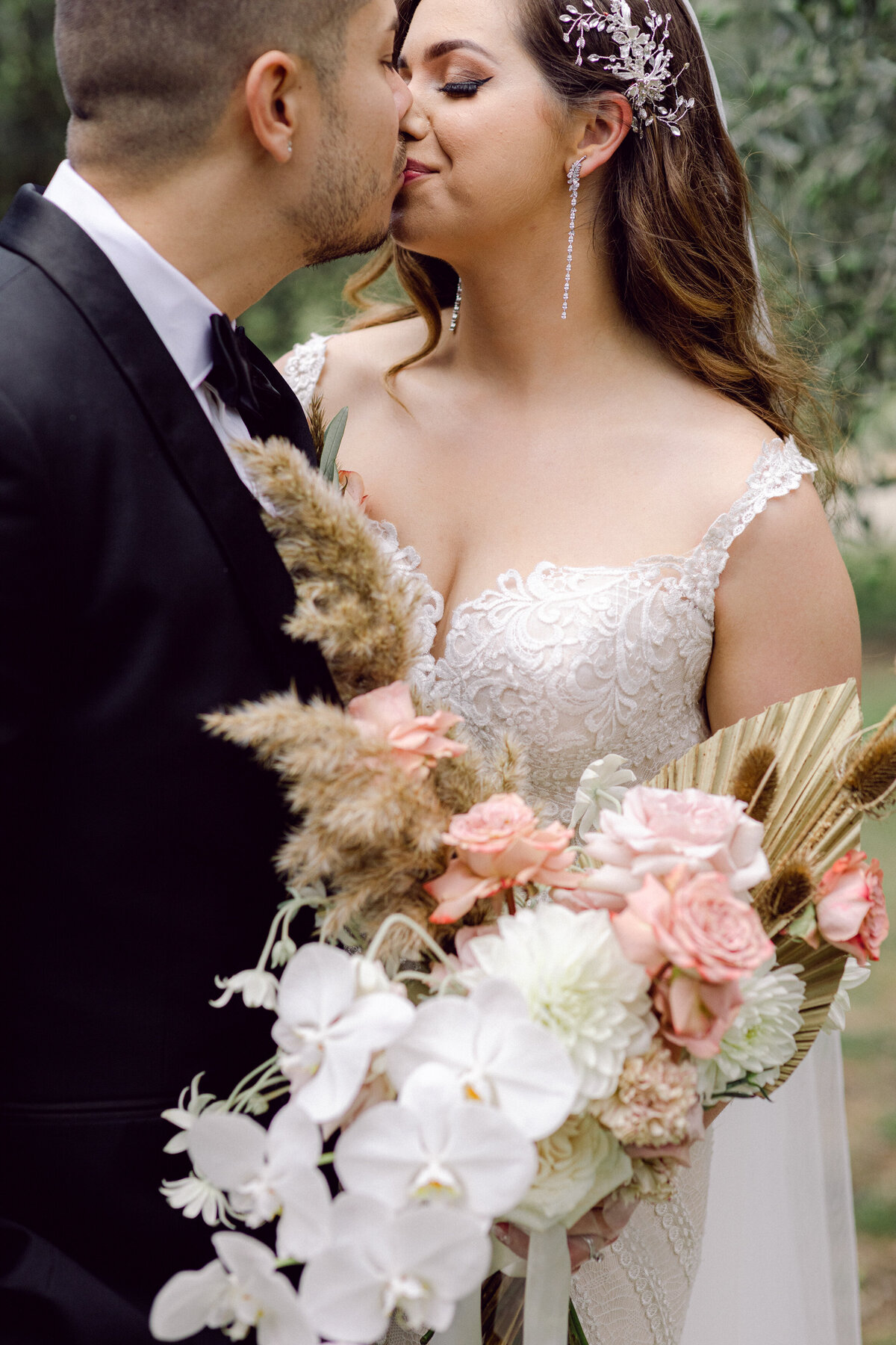 Bride and Groom's first kiss + wedding bouquet