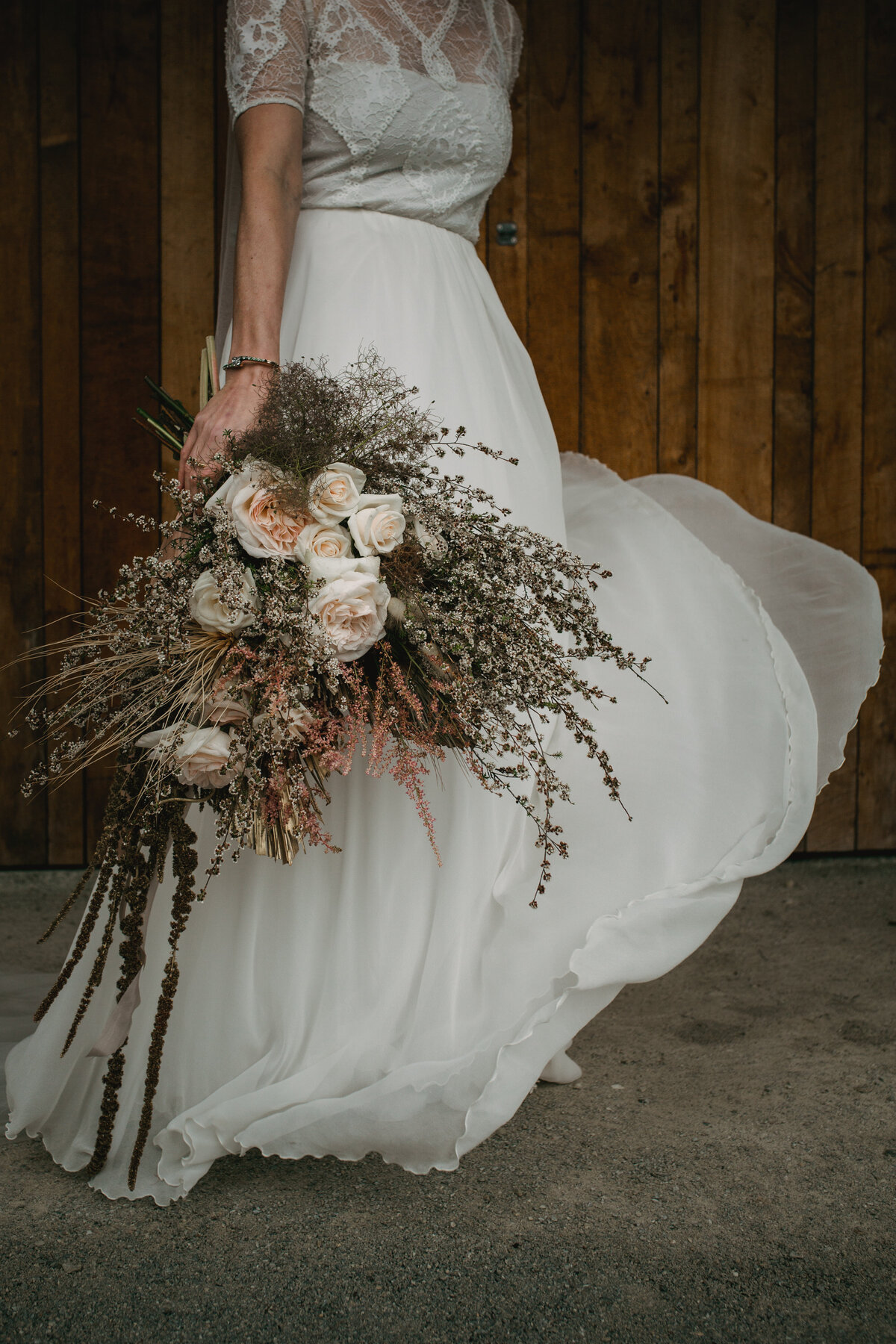 The Vase Floral Co - bride holds large floral bouquet to the side