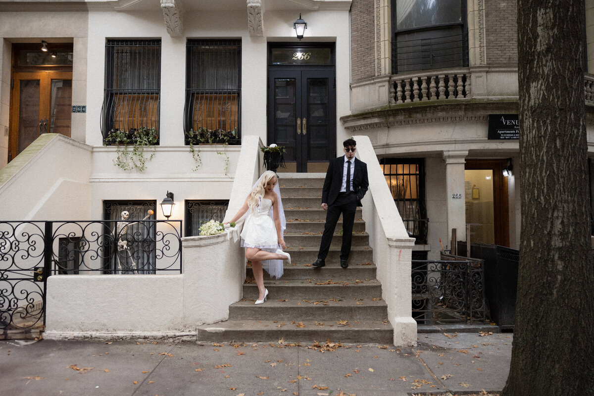 Couple sharing a quiet moment on a NYC step surrounded by city life.