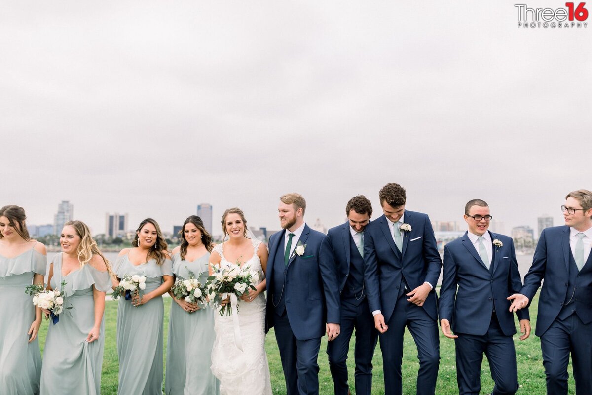 Bride and Groom goof off with wedding party during photo session