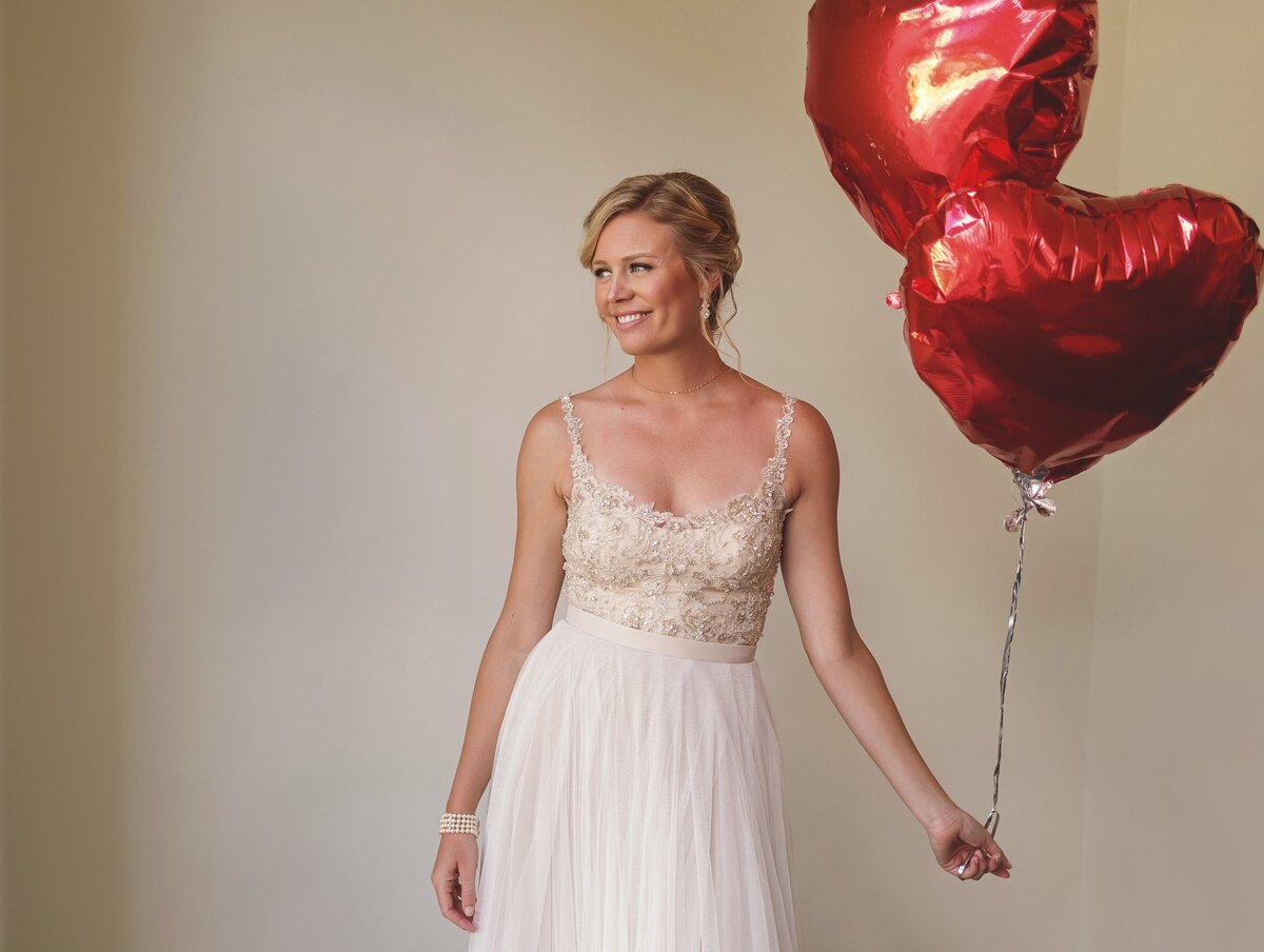 Bride with heart balloons before wedding