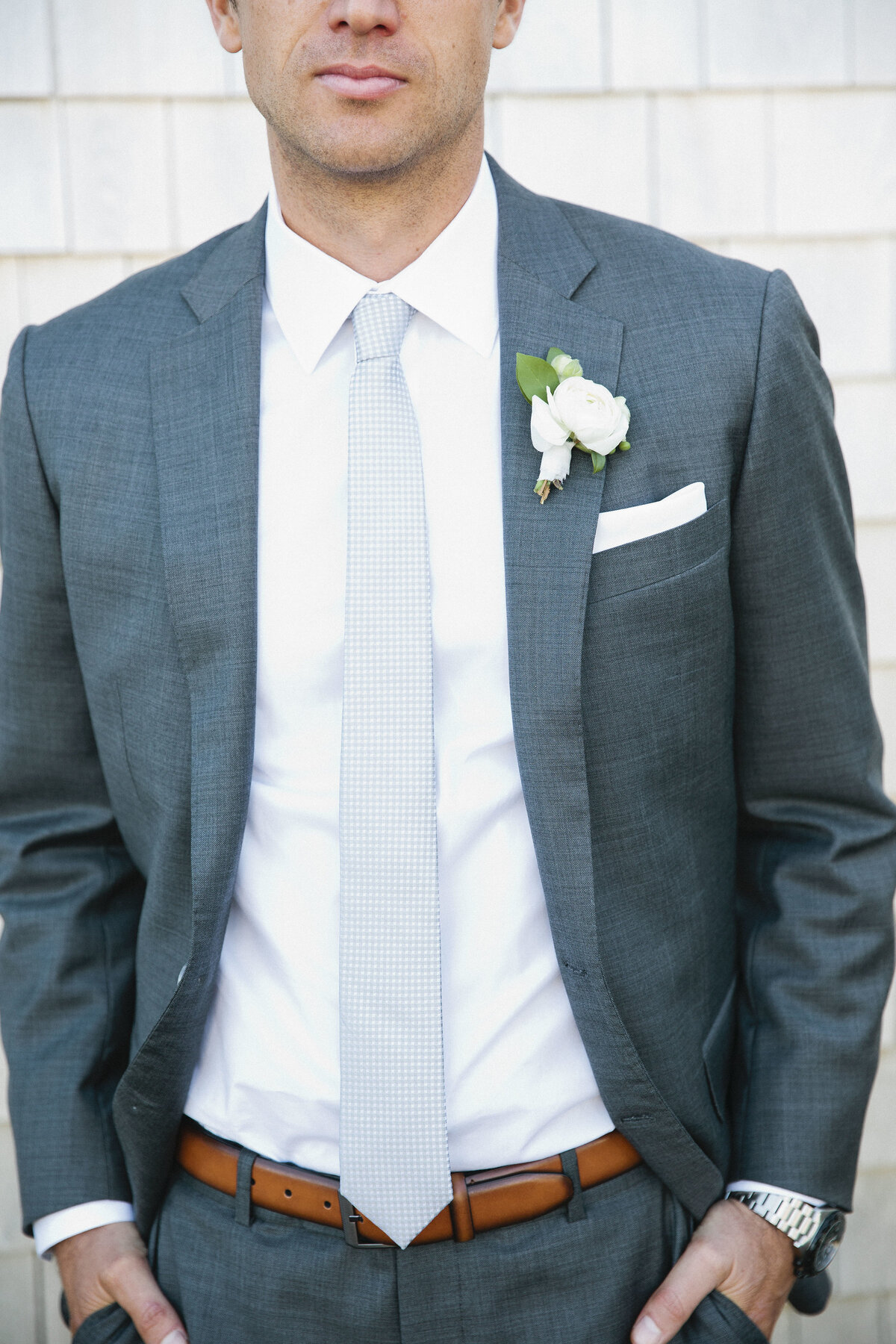 Gray custom suit and white boutonniere for groom on Cape Cod