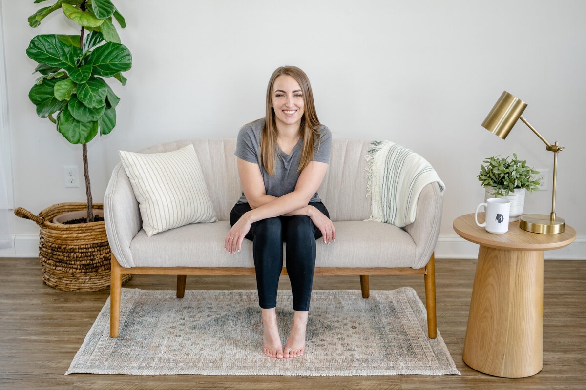 girl posing on couch hands crossed