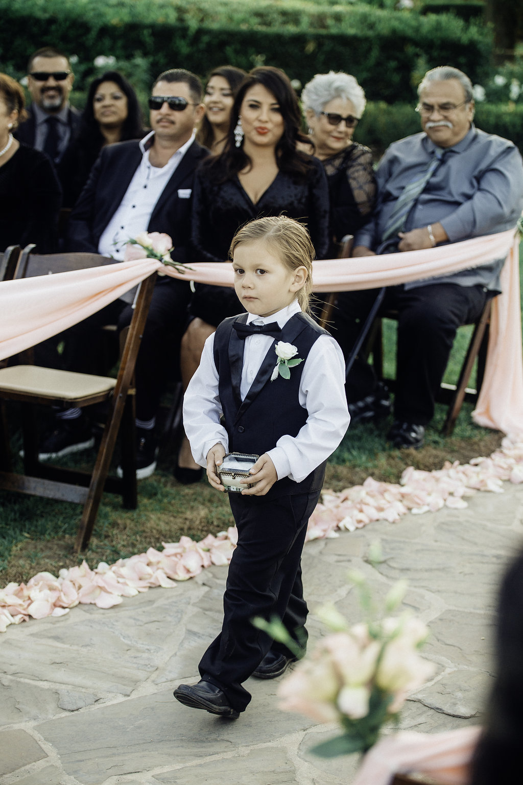 Wedding Photograph Of Ring Bearer Holding The Ring While Walking Los Angeles