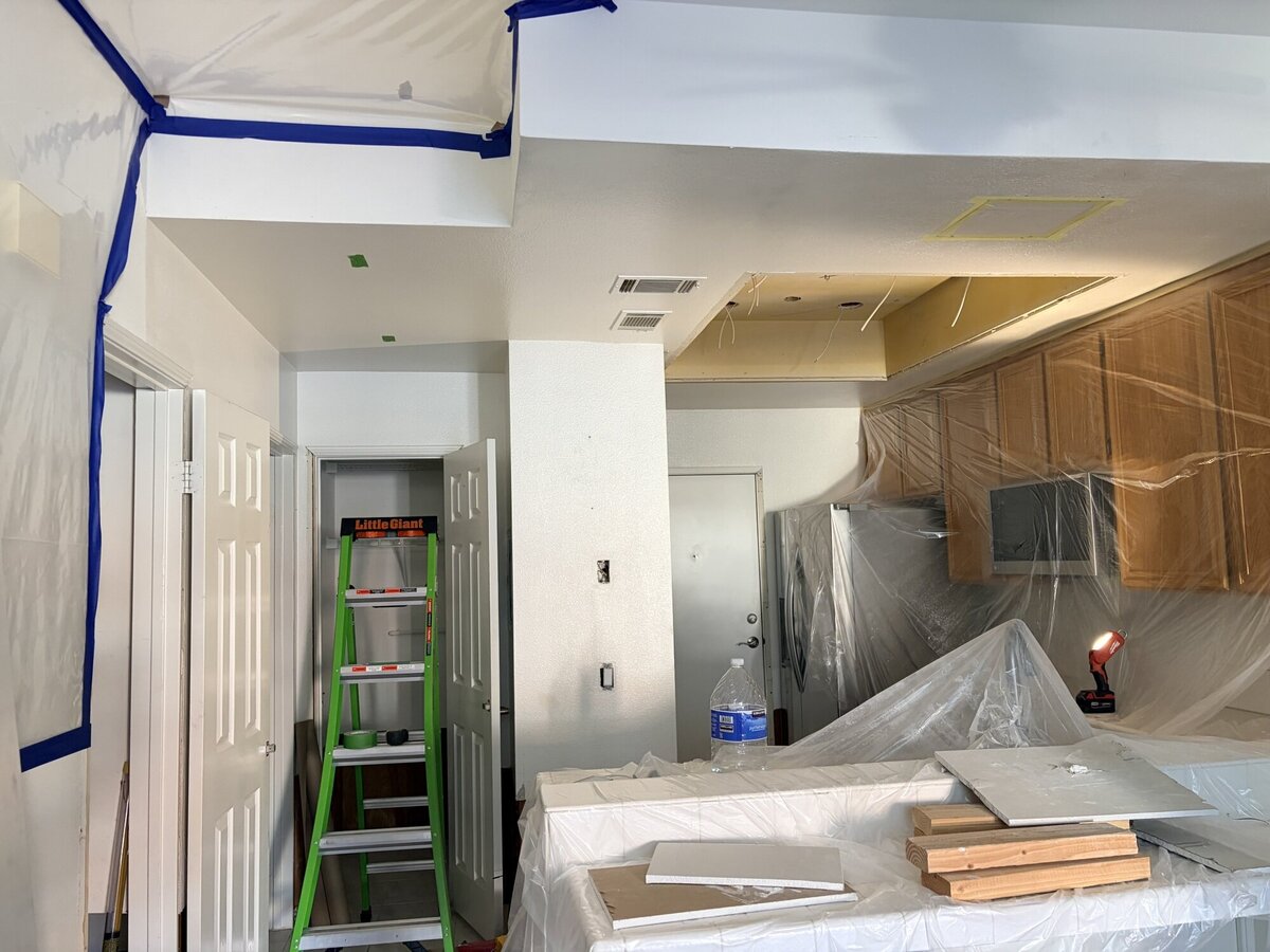 Kitchen and ceiling protected during interior painting preparation