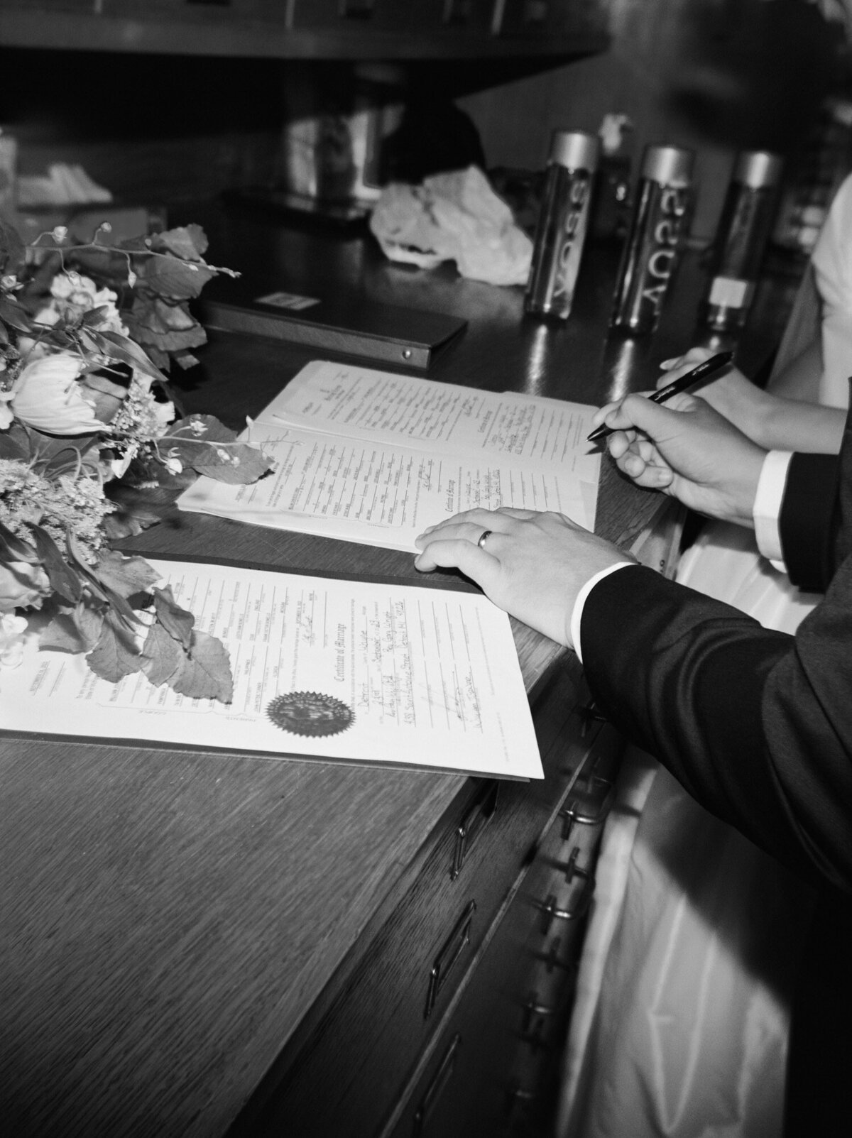 Natural film wedding photography in Detroit, wedding license being signed by groom