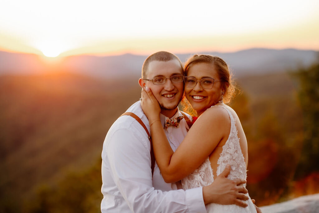 sunset wedding photos by wedding photographers gatlinburg tn of a couple eloping to Gatlinburg and embracing on the parkway with the mountains in the distance