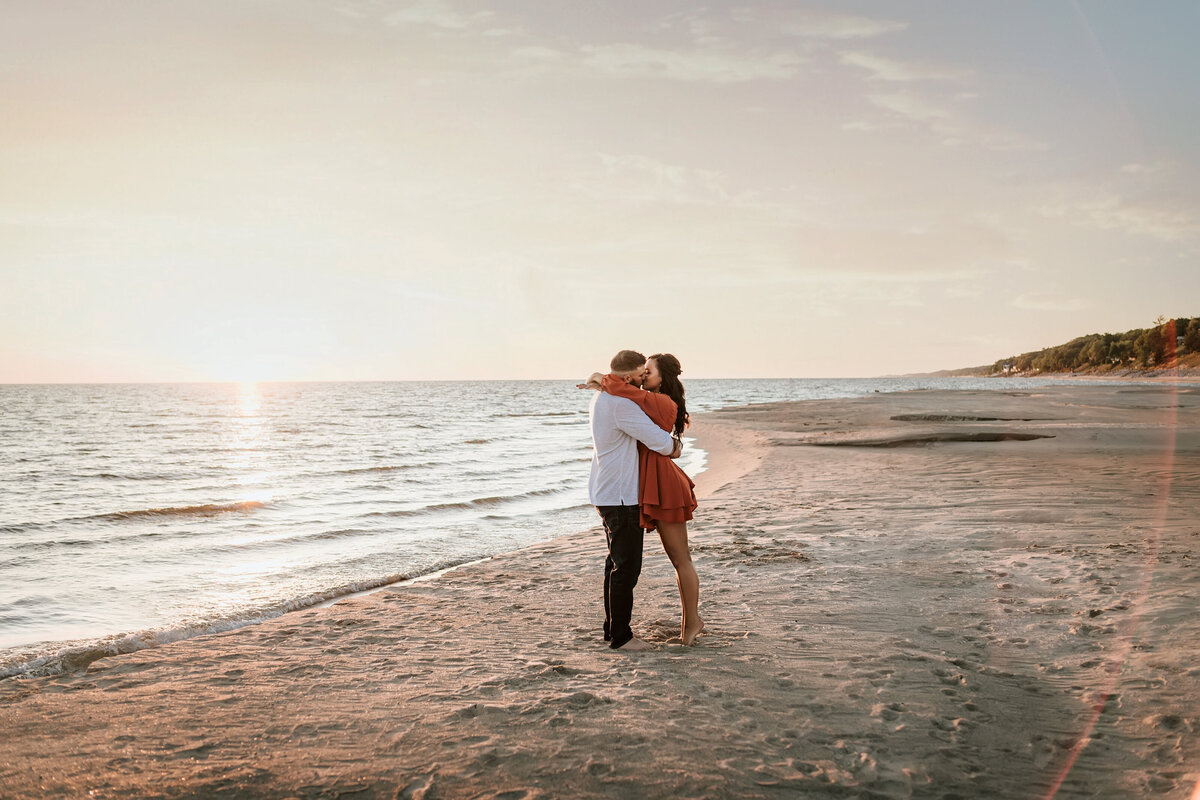 couple on beach lake michigan engagement
