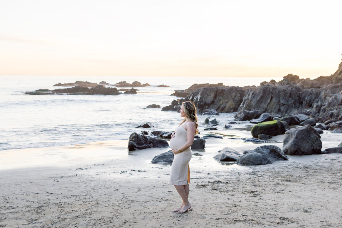 candid maternity photo on the beach