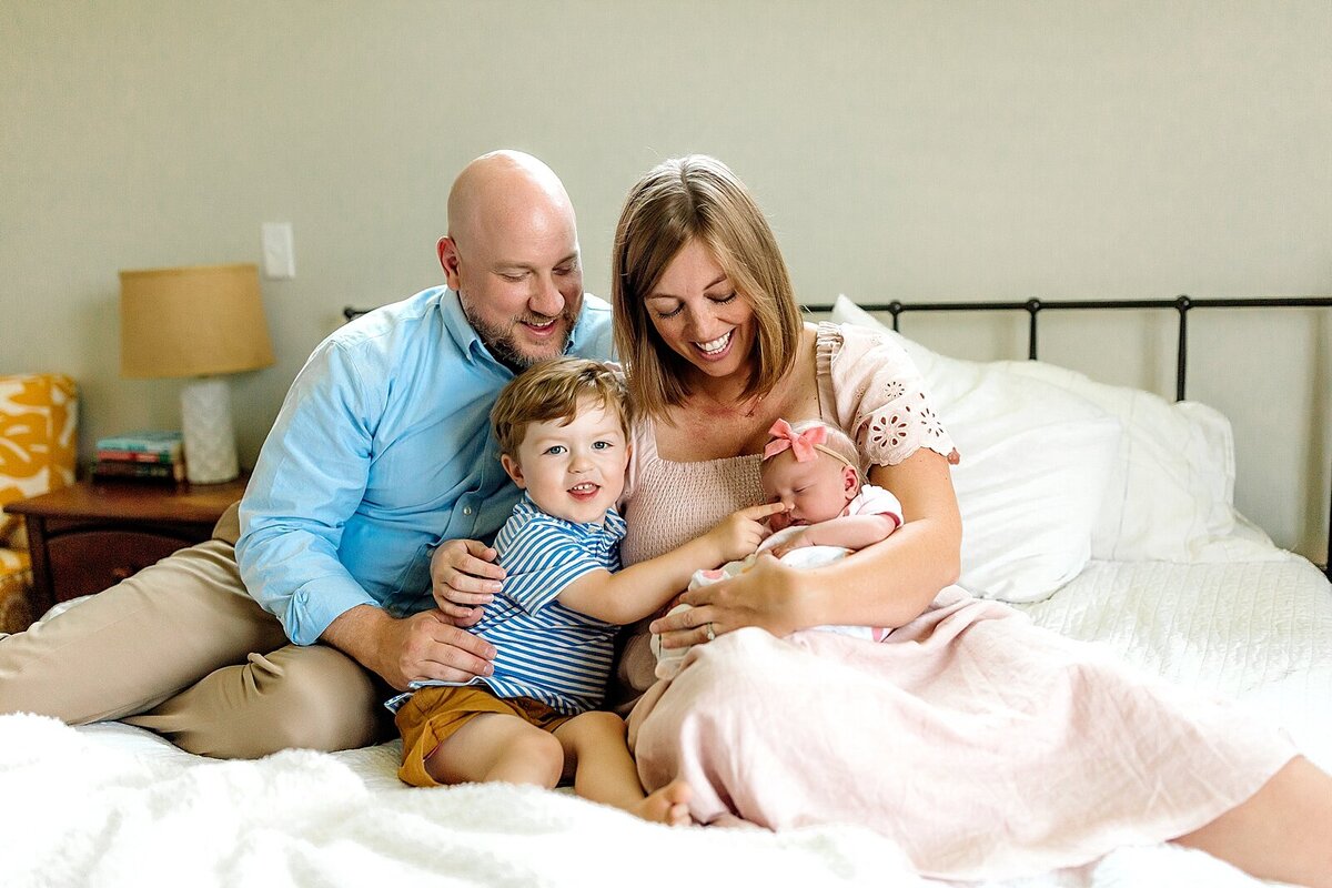 Lifestyle newborn session with family on bed Charlottesville, VA