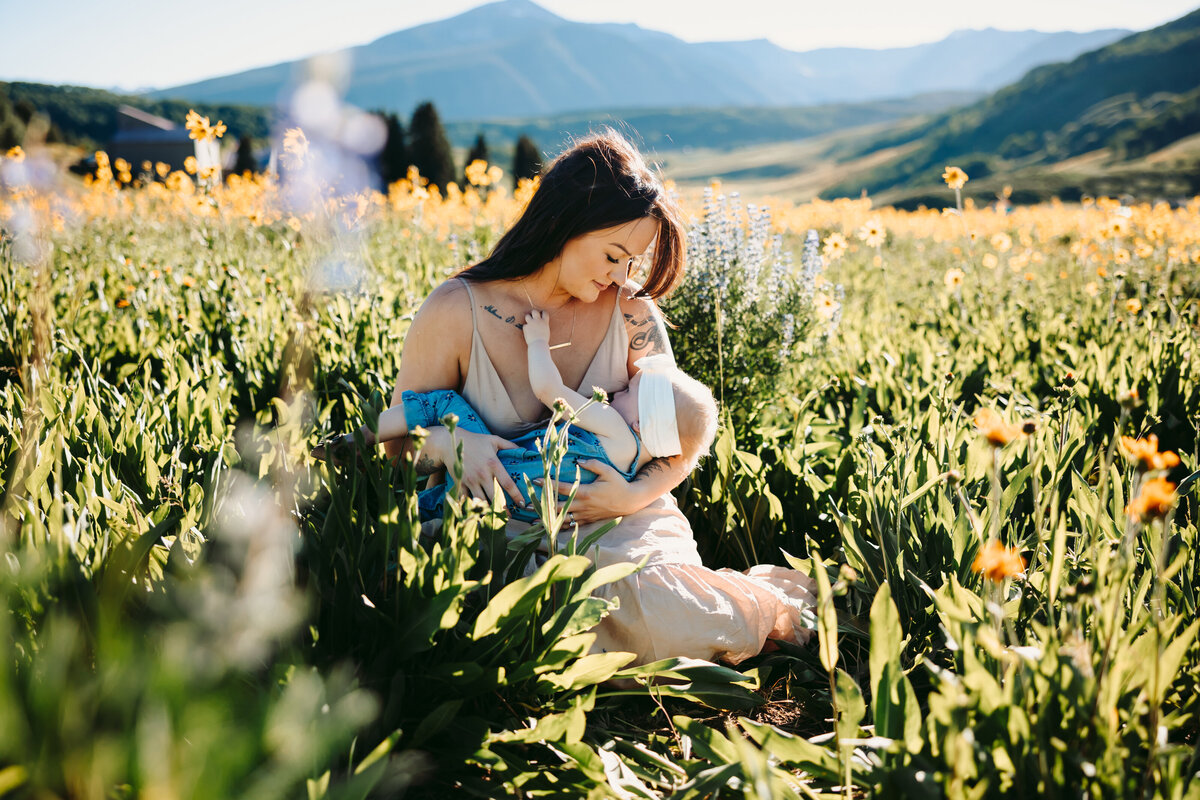 breastfeeding portrait in wildflowers in Crested Butte.