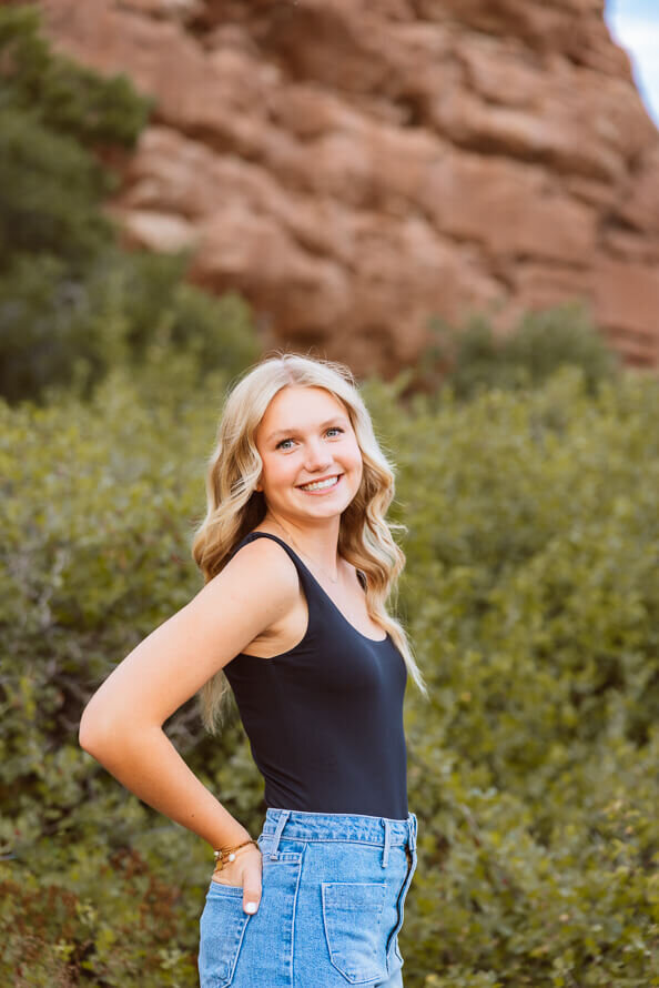 Girl in black tank top smiles at Angela Marie Media's camera.