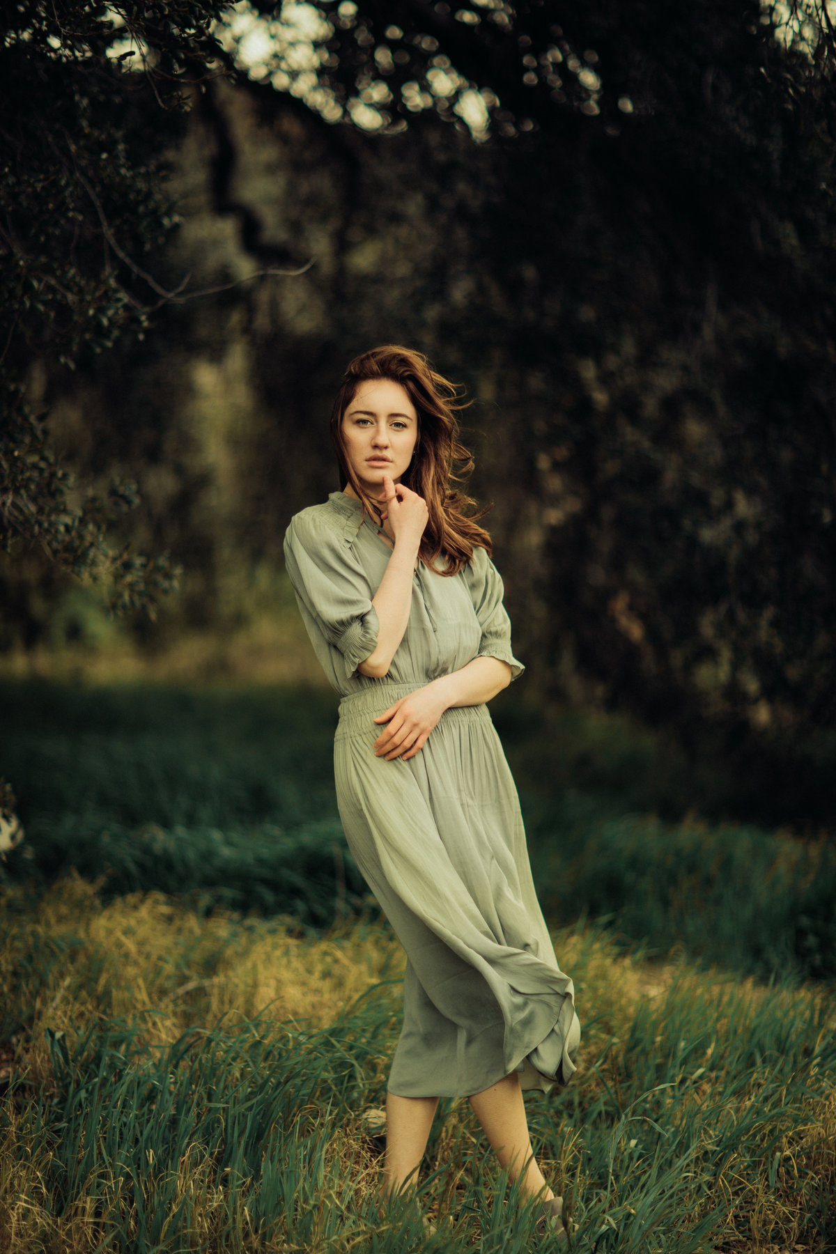 Portrait Photo Of Young Woman In Dress Holding Her Chin And Waist Los Angeles