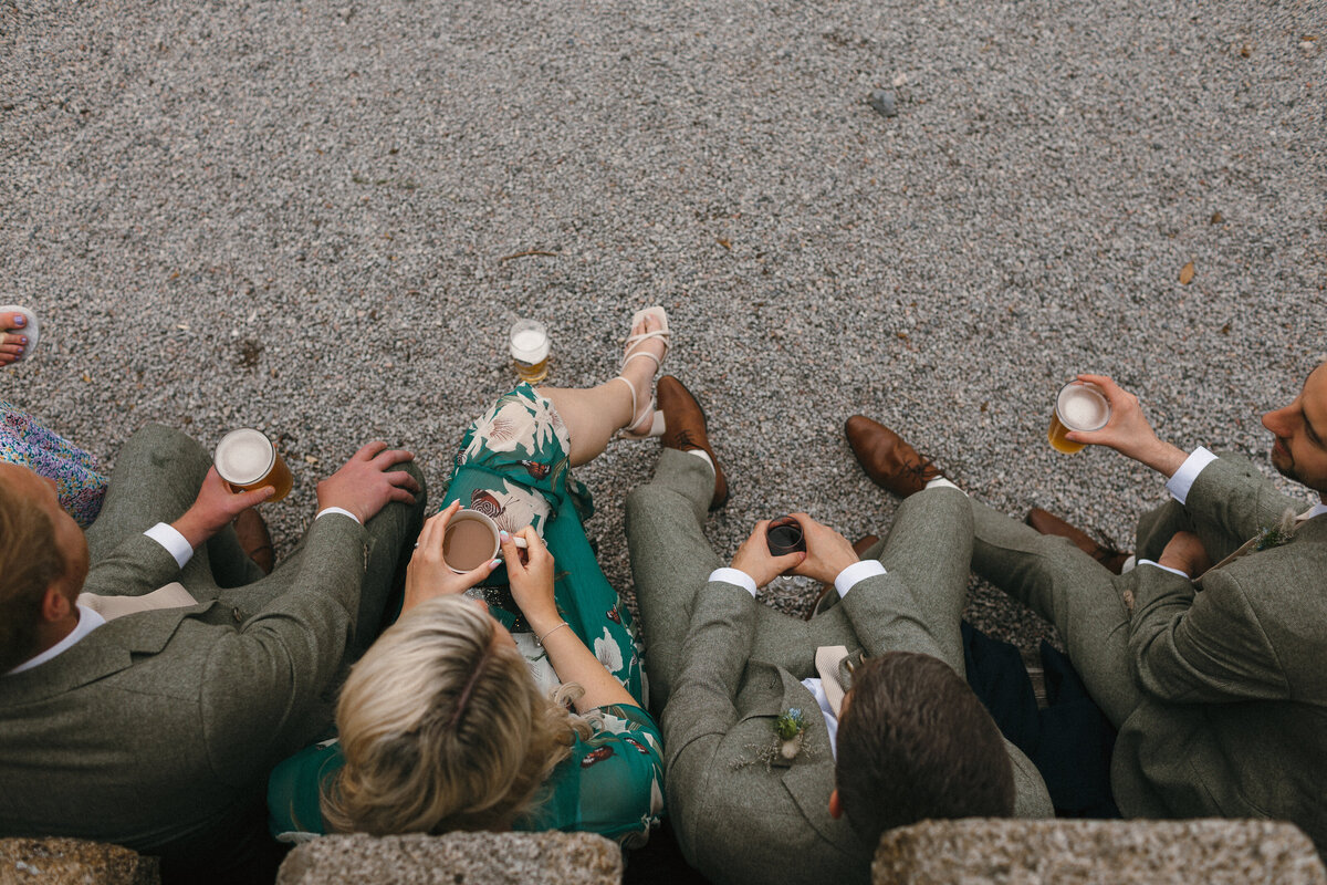 Arial shot of guests and groom at wedding drinking together
