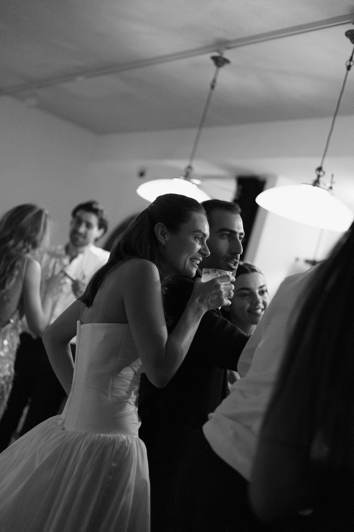 Bride smiling while dancing with groom during live band performance

