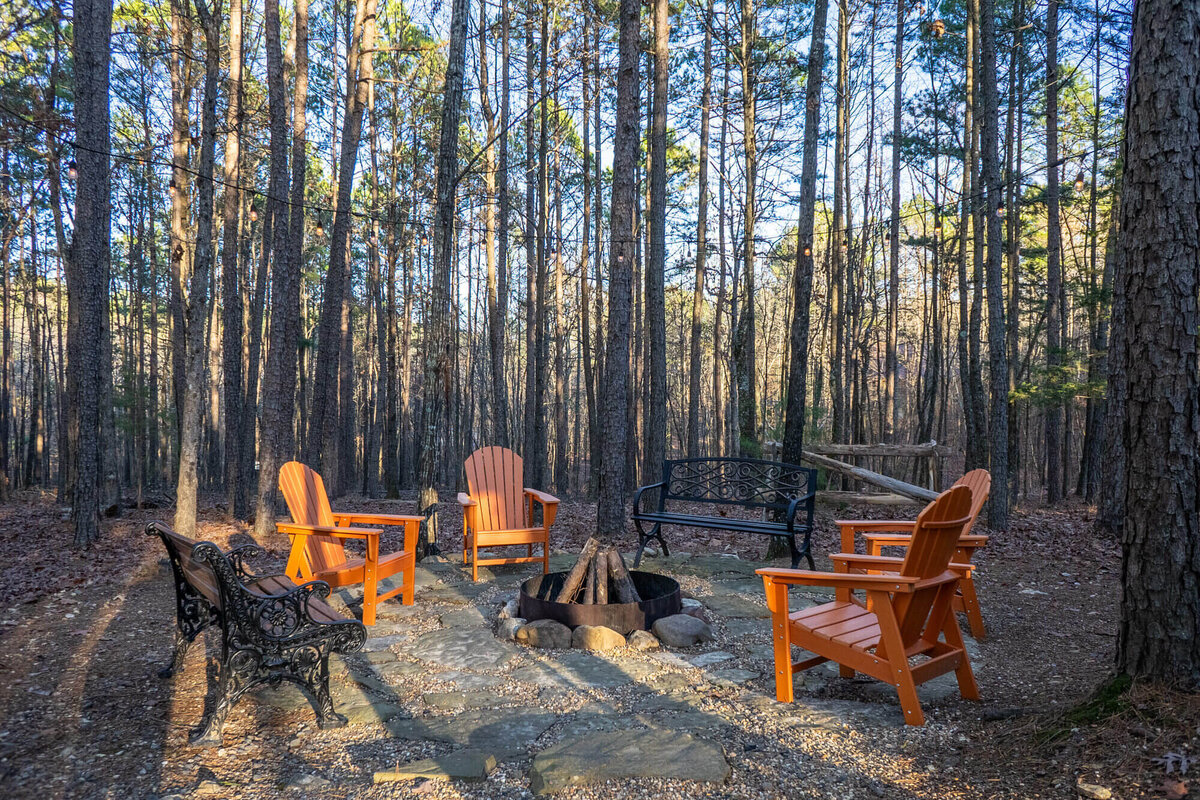 Campfire fire pit with warm string lights and outdoor sitting area