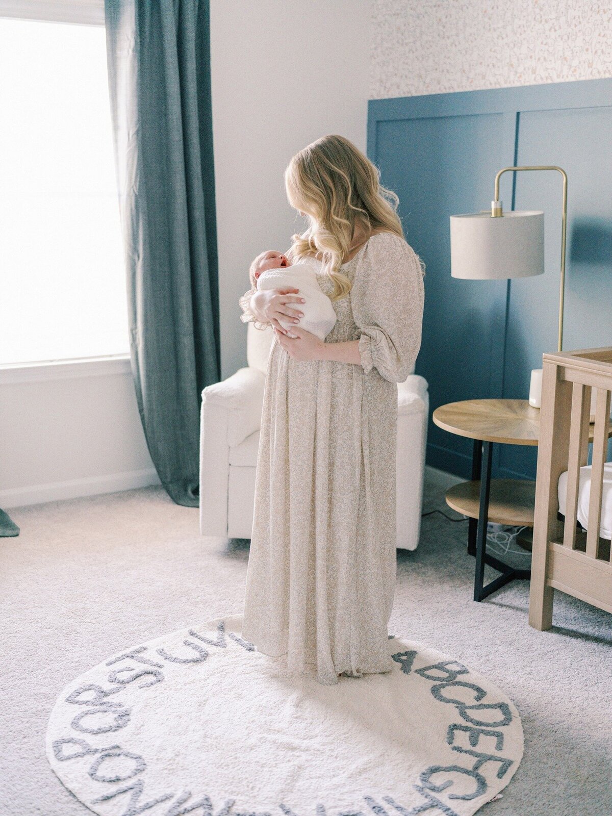mom-holding-newborn-in-nursery