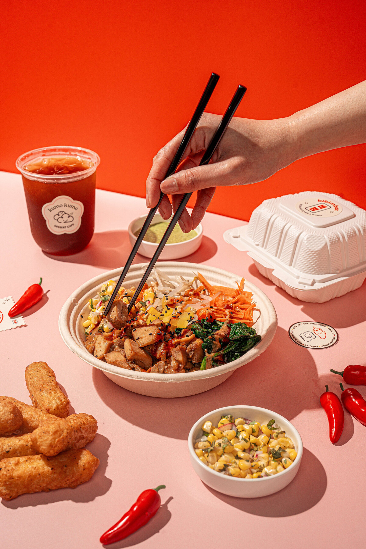 Food product photography in Columbia, SC featuring a hand and chop sticks picking up tofu