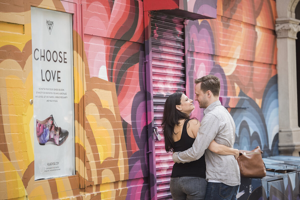 A couple with their arms around each other about to kiss