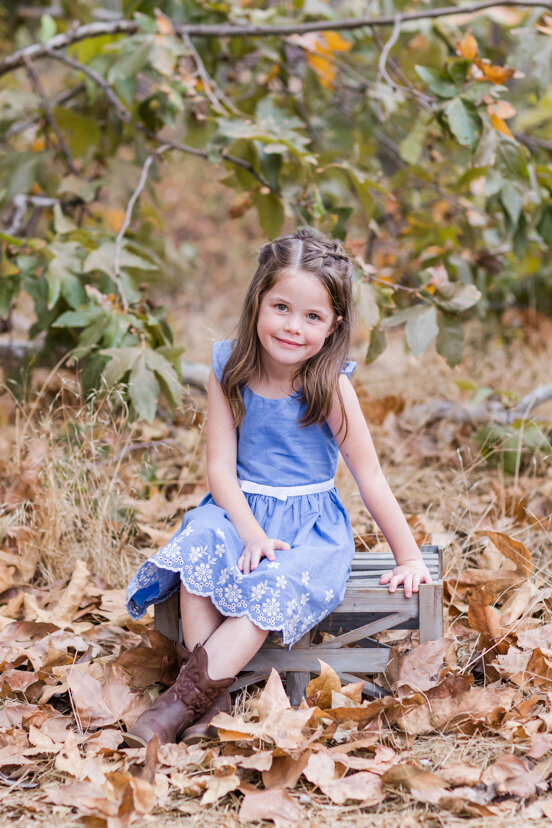 young-girl-sitting-in-leaves--sweetwater-river-bridge-san-diego