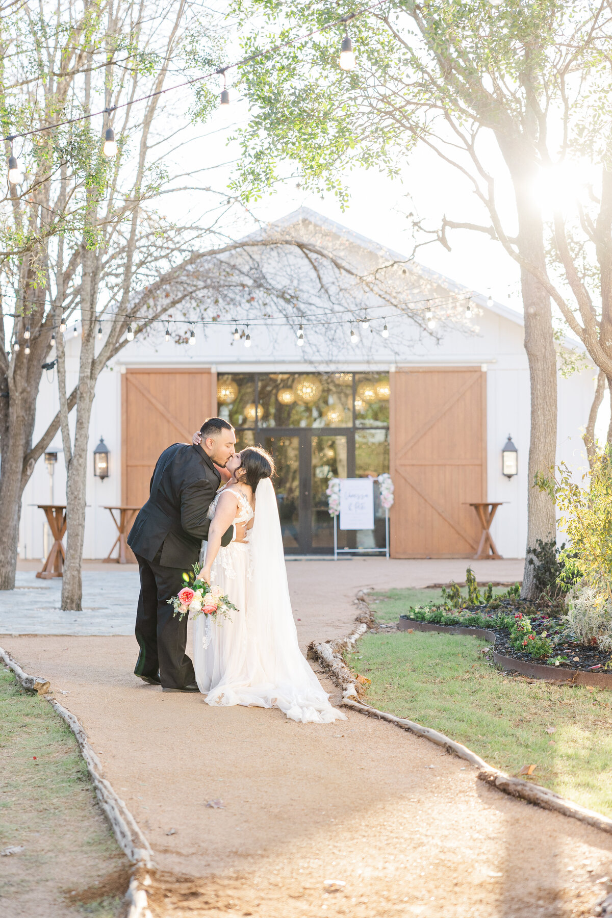 San Antonio wedding photographer captures bride and groom outside a San Antonio wedding venue kissing.