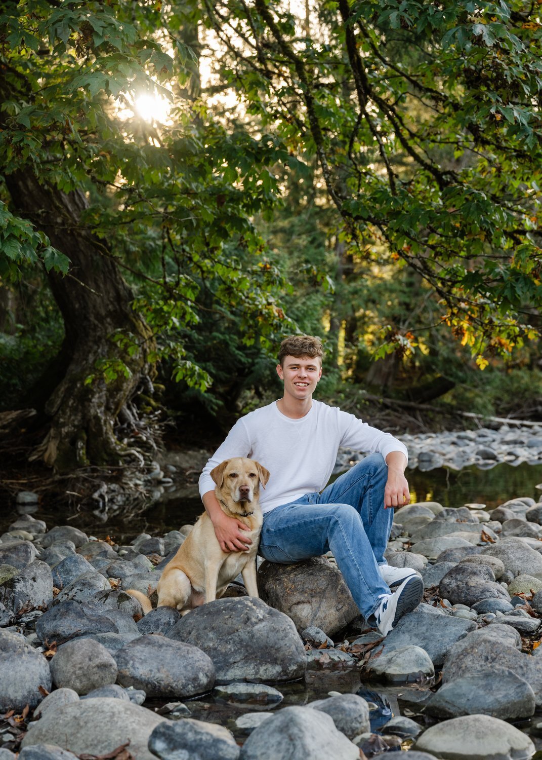 north bend senior and dog at river park on rocks