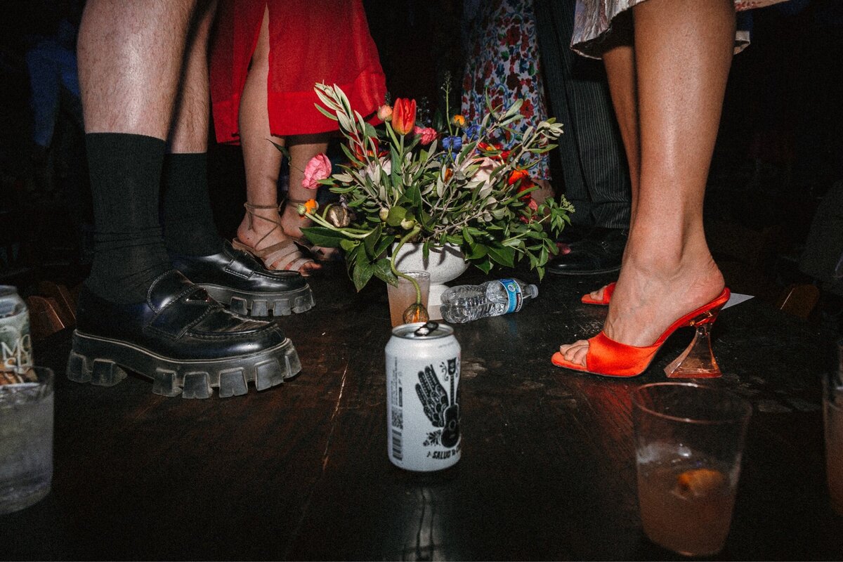 documenraty style image of people dancing on tables at a wedding 