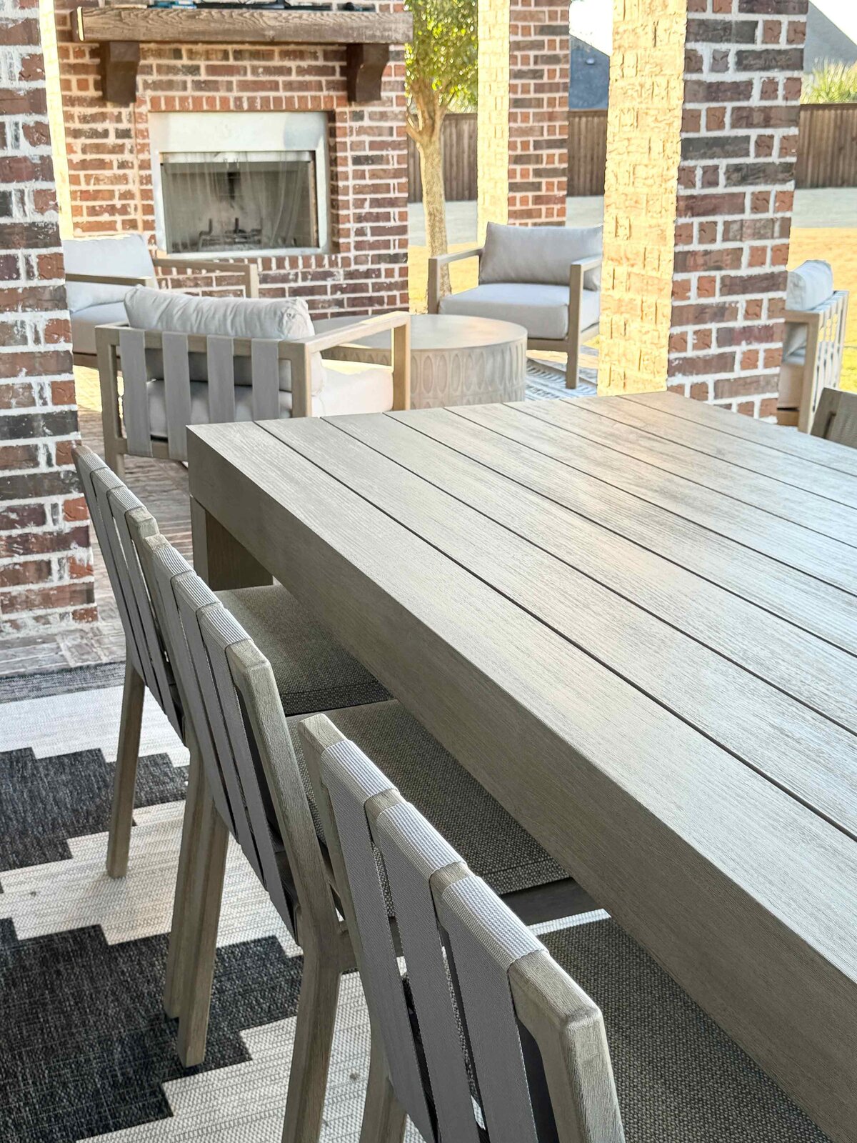 Residential interior design solution for an outside living room with a close-up of a stylish dining table, blending elegance and functionality in the outdoor space.
