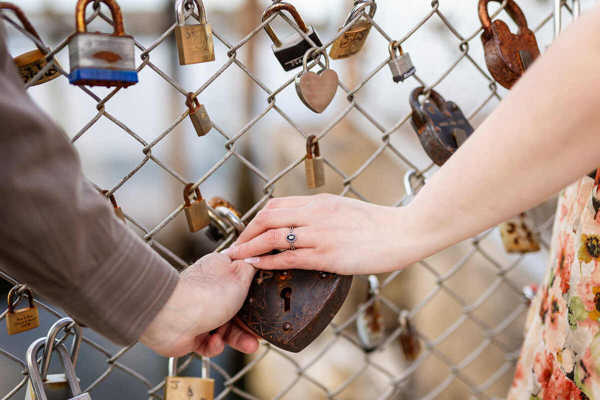 Couple holding lock at Locks of Love fence in Portsmouth NH