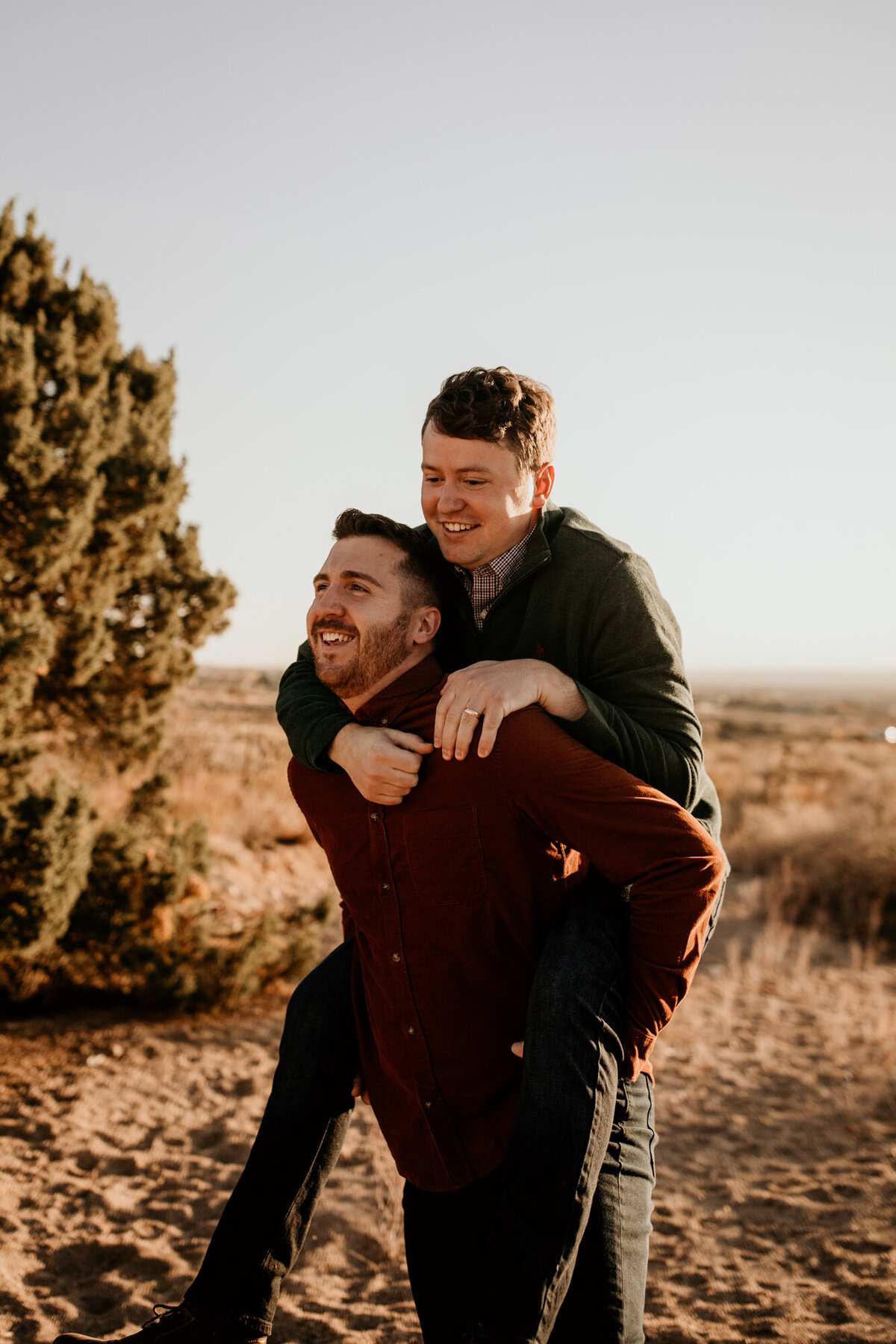 piggy back ride with gay couple in the desert laughing