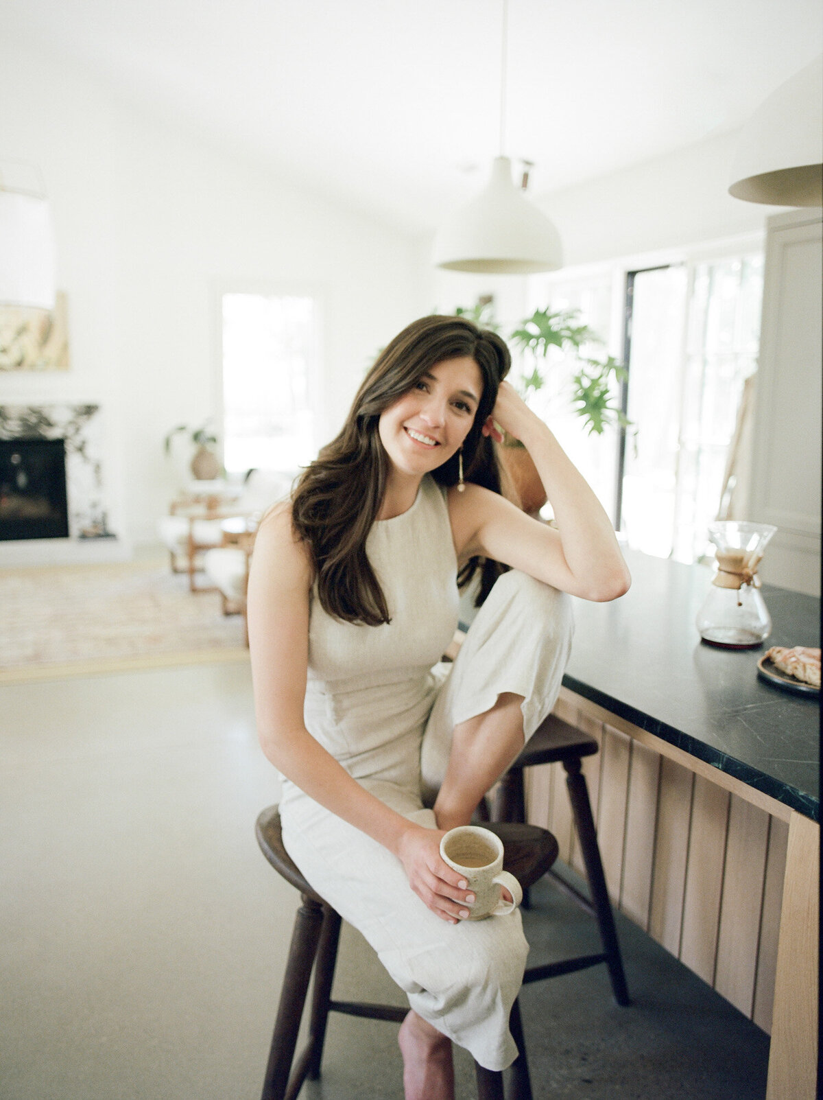 smiling designer in kitchen of Fernhaus, interior design space, film designer brand photos in Michigan