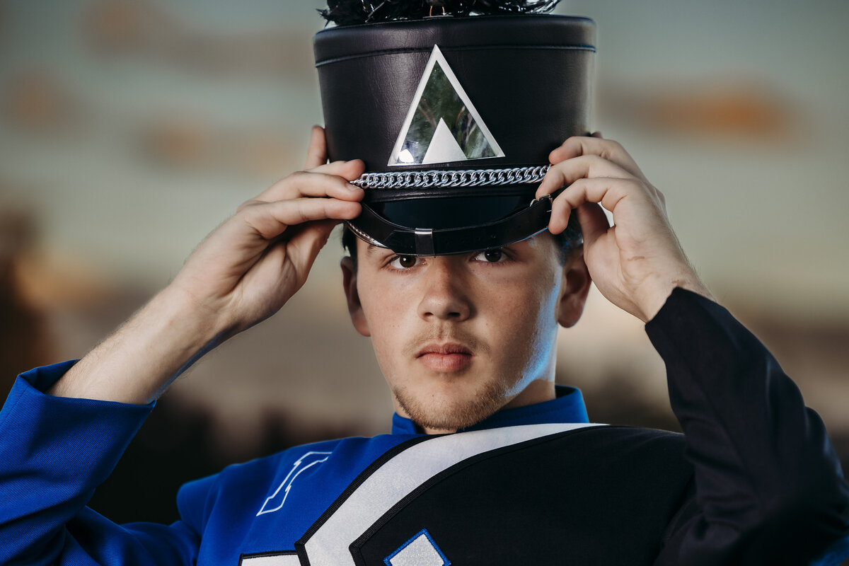 teen-holding-marching-band-hat
