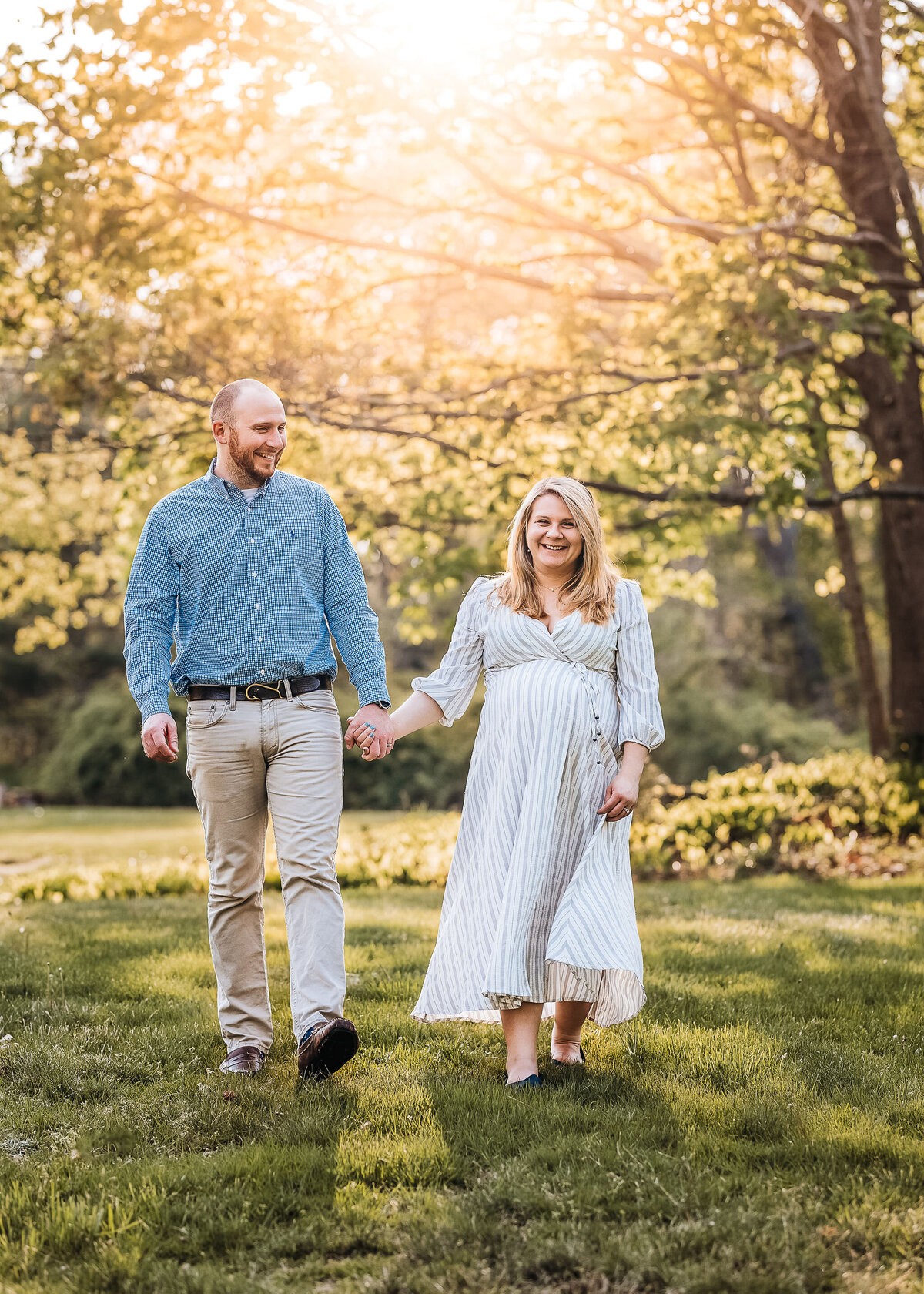 Husband and wife holding hands in maternity photo by lisa Smith Photography