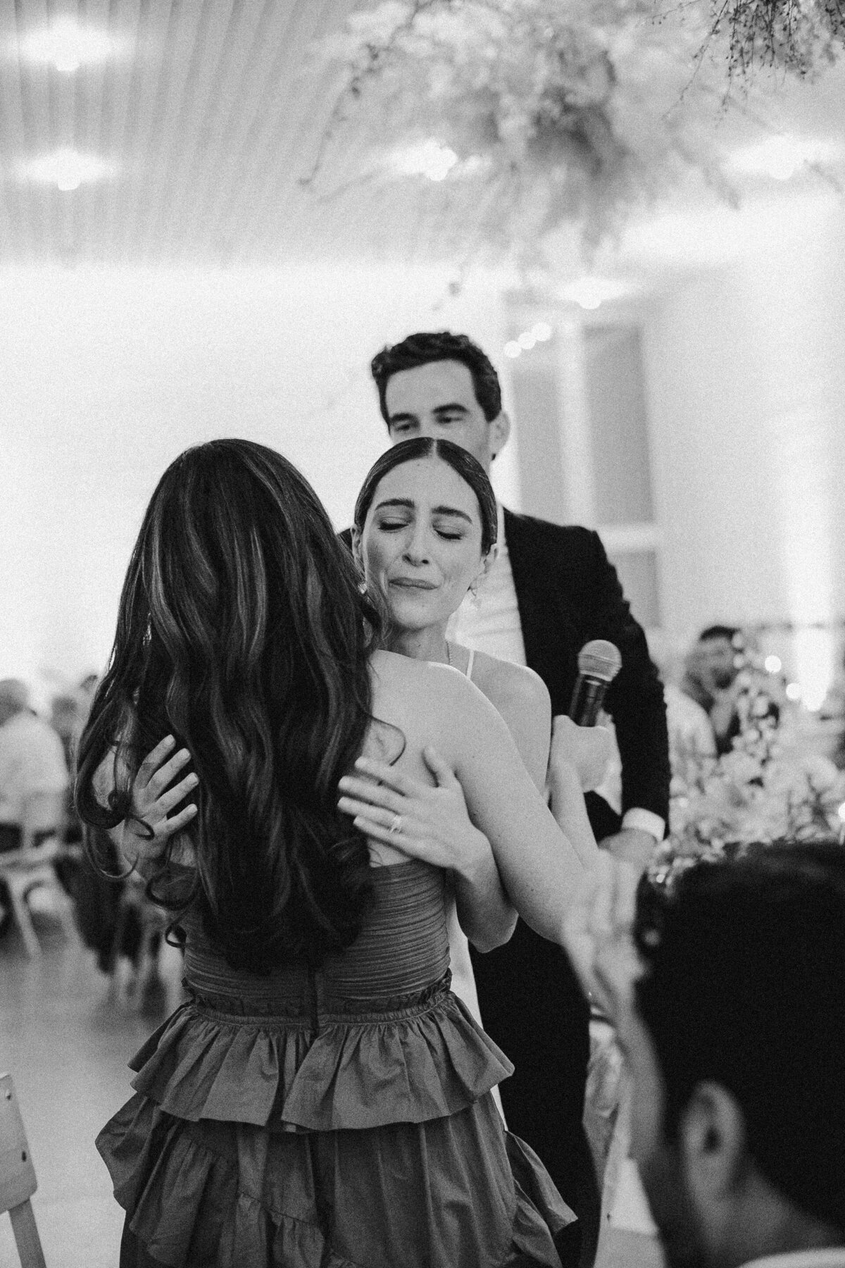 Bride hugging a guest at wedding reception at Prospect House , Austin