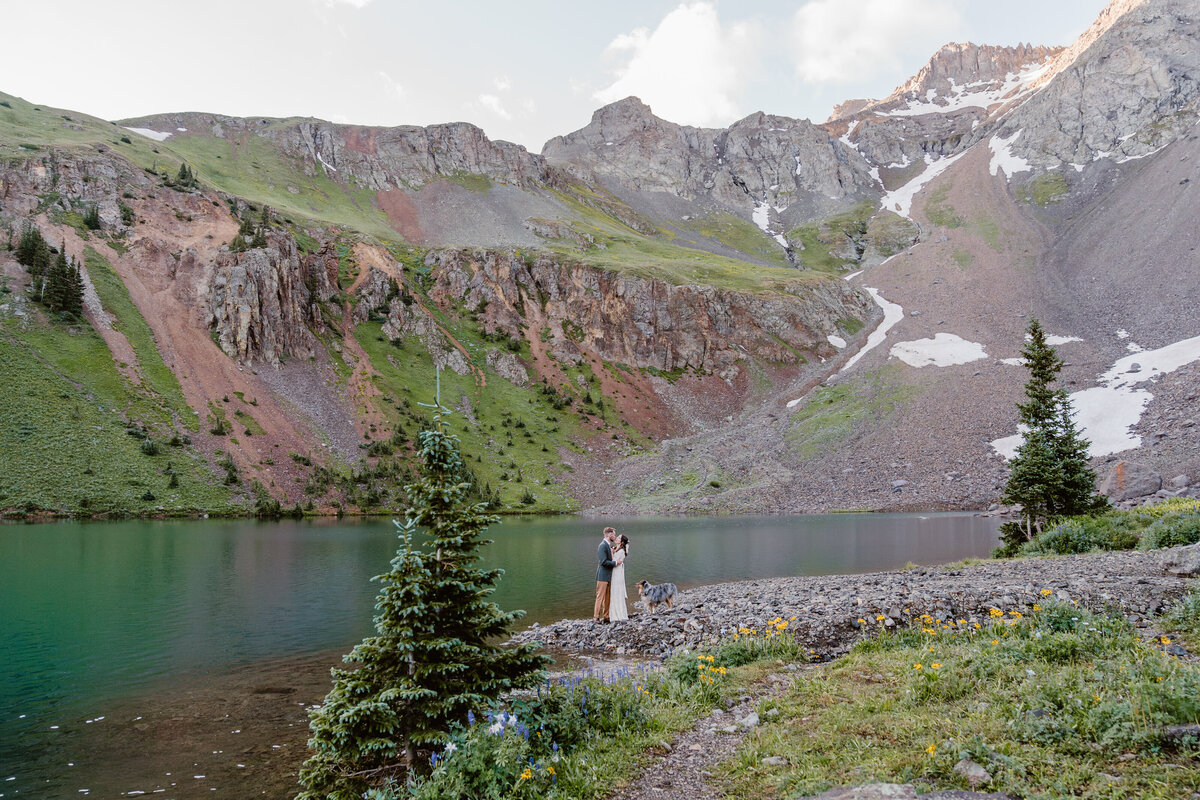 Couple elopes at the foot of an alpine lake in Telluride, Colorado