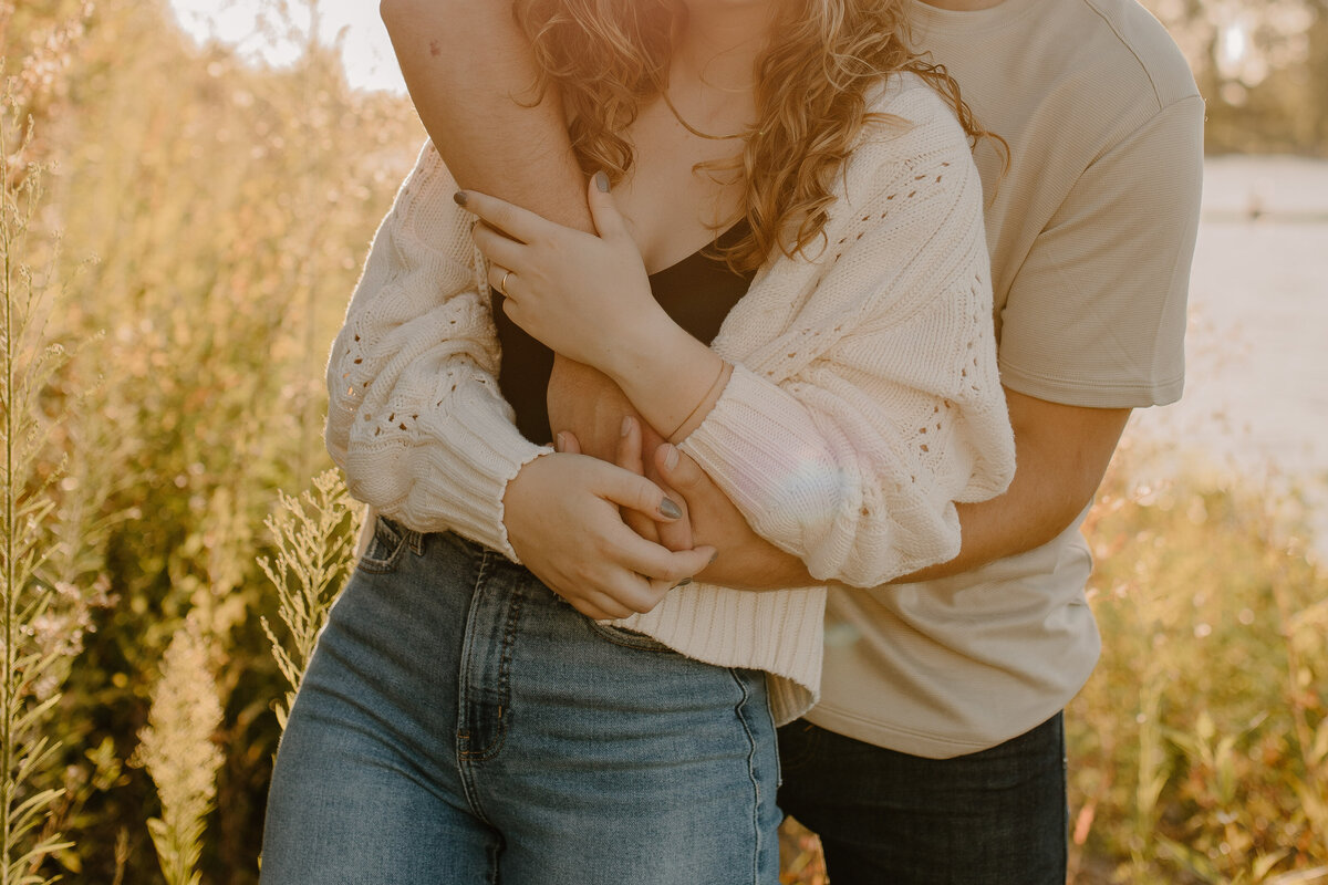 guy wrapping arms around girl
