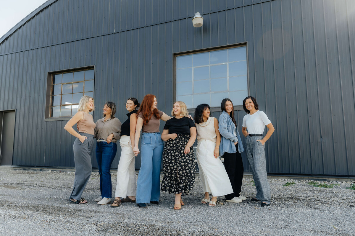 Group of diverse women laughing together outside studio, natural and empowering brand photography for creative teams and small businesses